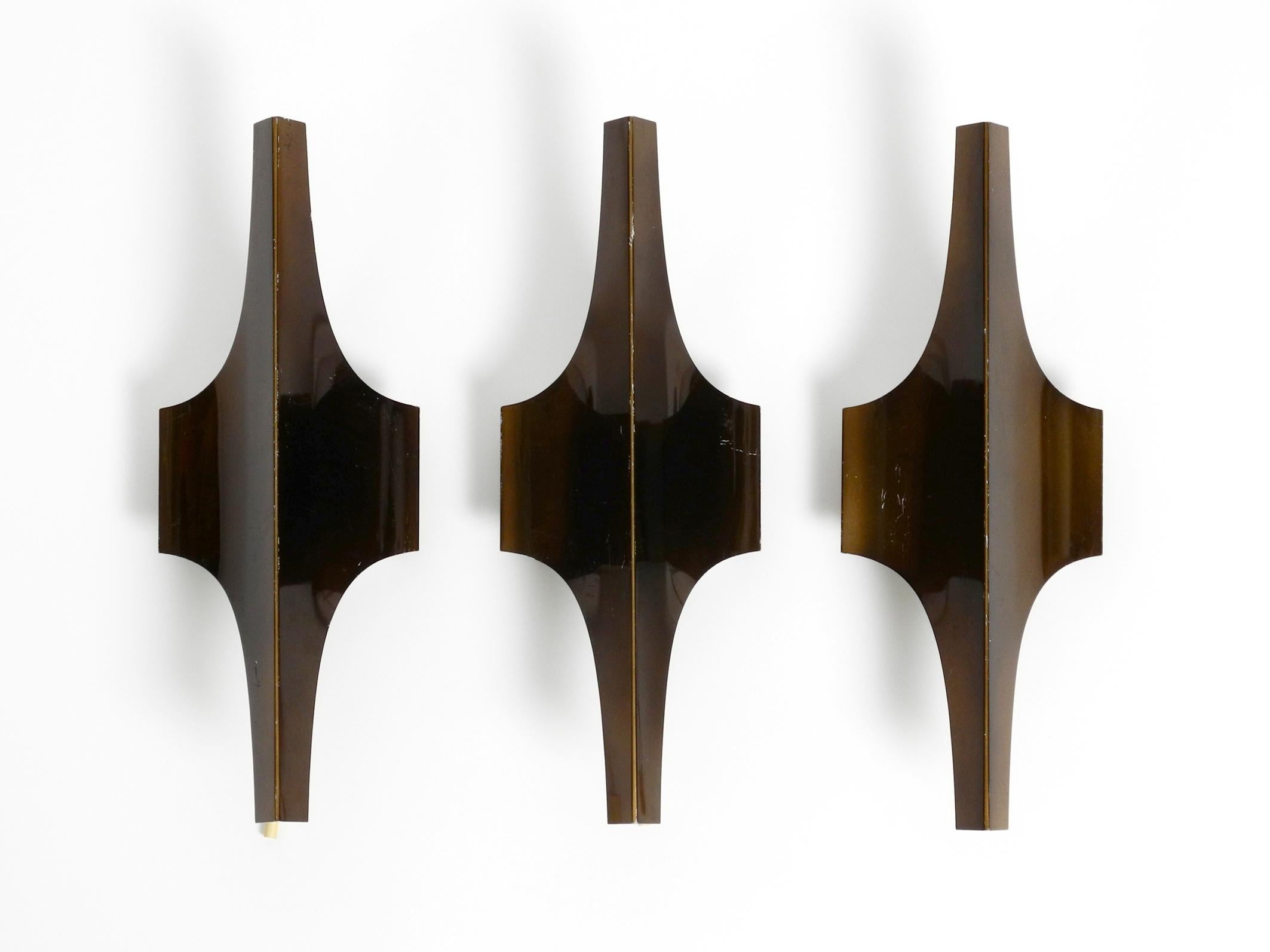 Three Space Age design wall lamps in metal anodised in bronze colour.
Design by Wilhelm Braun-Feldweg for Doria. Made in Germany.
Very special 1960s German design.
Great futuristic shape, typical for that time.
In good vintage condition with a