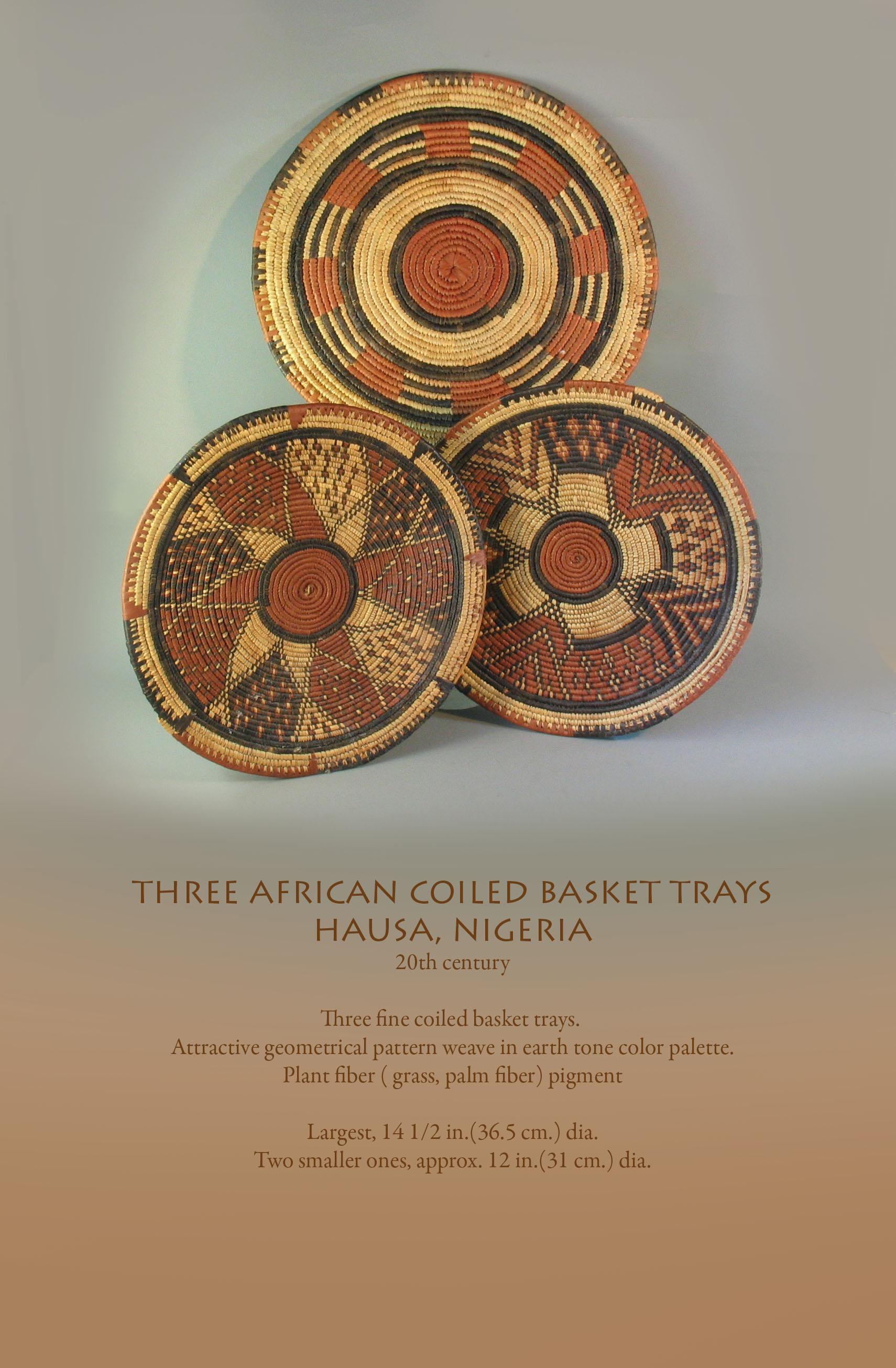 Three African coiled basket trays
Hausa, Nigeria
20th century.

Three fine coiled basket trays. 
Attractive geometrical pattern weave in earth tone color palette.
Plant fiber (grass, palm fiber) pigment

Measures: Largest, 14 1/2