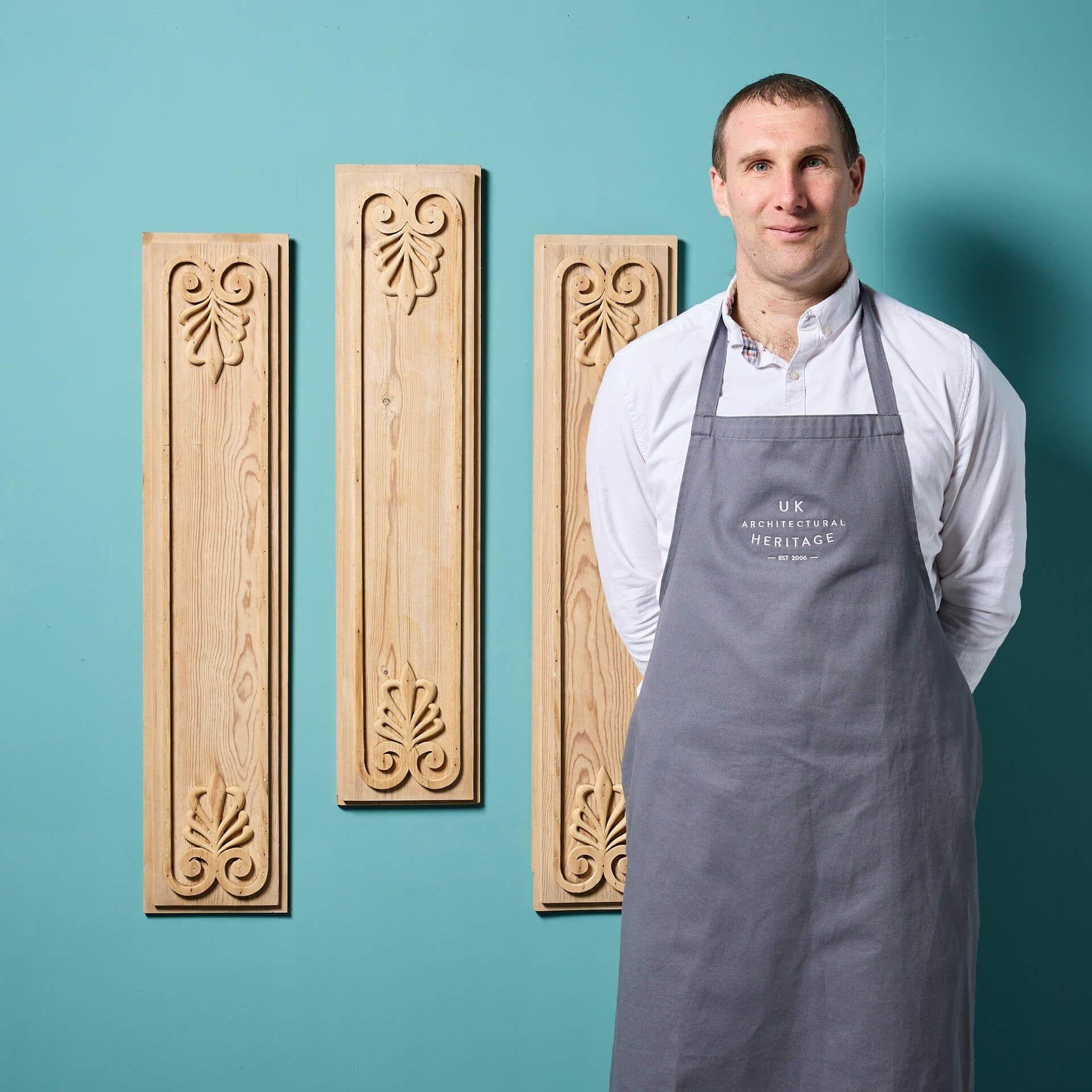 A set of three antique carved pine anthemion panels. Dating from the early 19th century, these neoclassical style panels – of slightly varying sizes – are originals from the Georgian period. Stripped and fitted with hanging hooks for wall mounting,