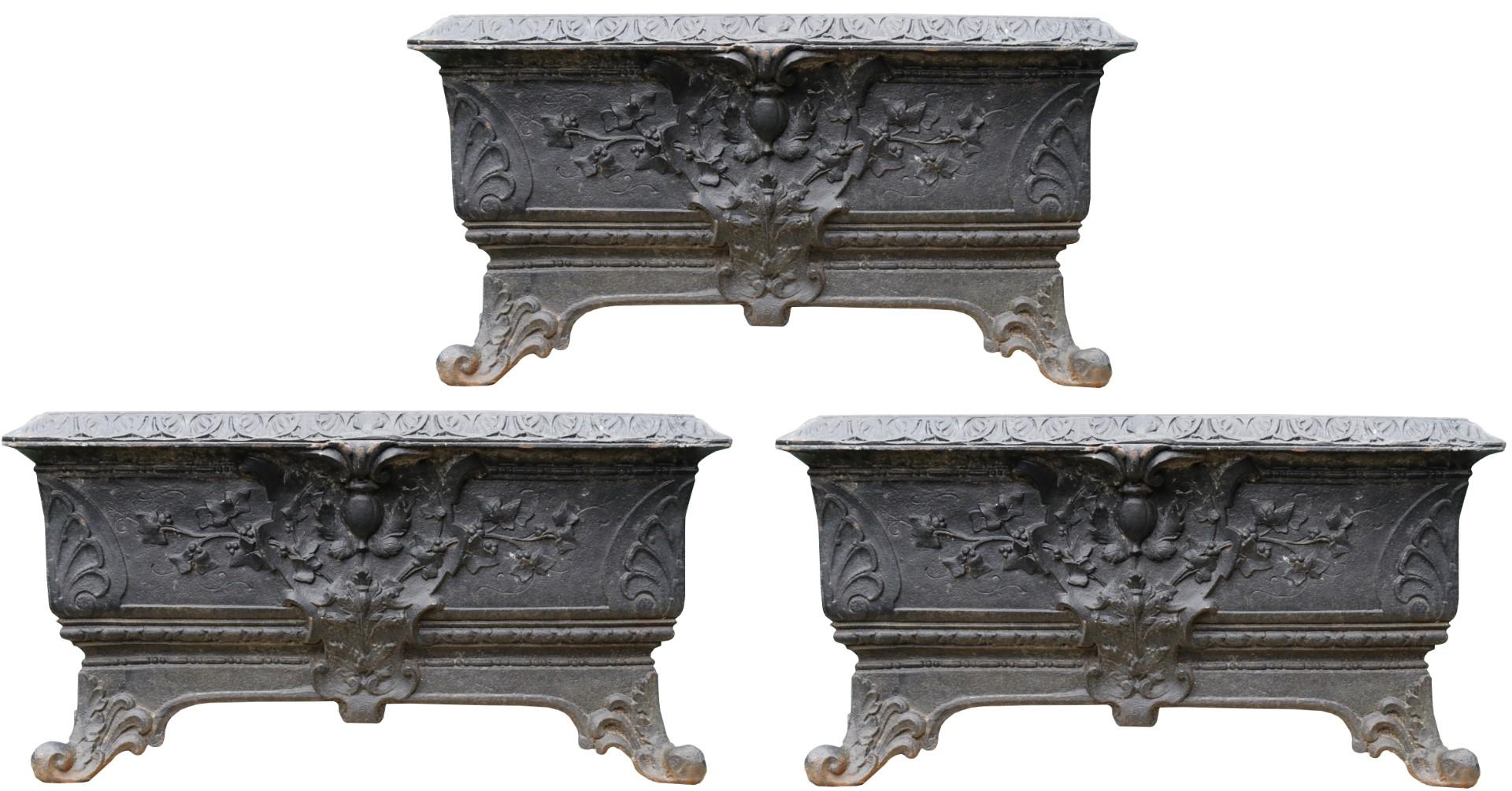 Three cast iron planters of rectangular form, with flared sides and scroll feet, the body ornamented with central cartouche.

Additional Dimensions (Each)

Height 38 cm

Width 73.5 cm

Depth 36.5 cm

Opening Height 29 cm

Opening Width
