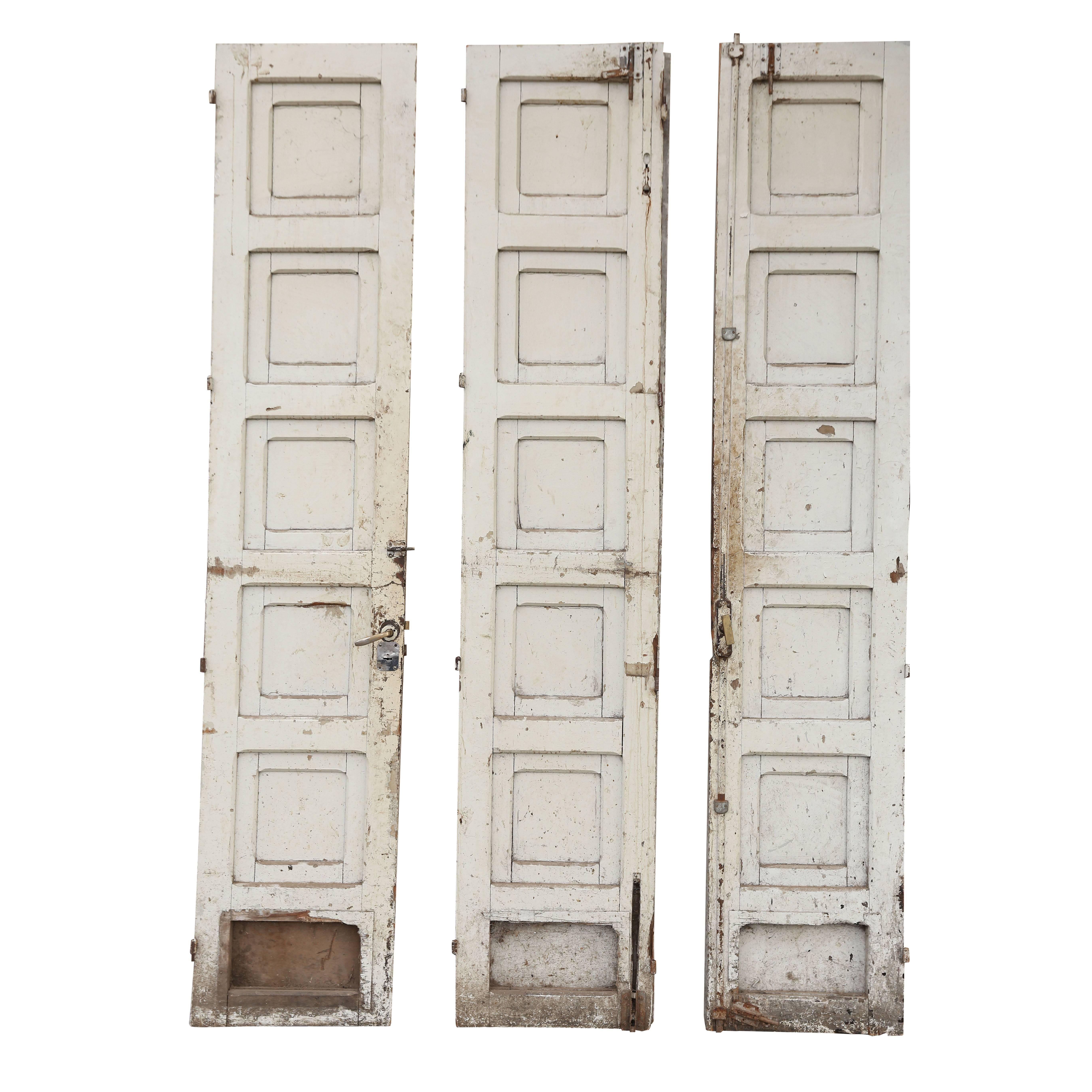 Three antique painted French doors, heavy painted antique wooden doors (circa 1910-1930, France), deeply carved with geometrical moldings, in their original paint. Two doors hinge together and attach to the right side of the doorway and the third