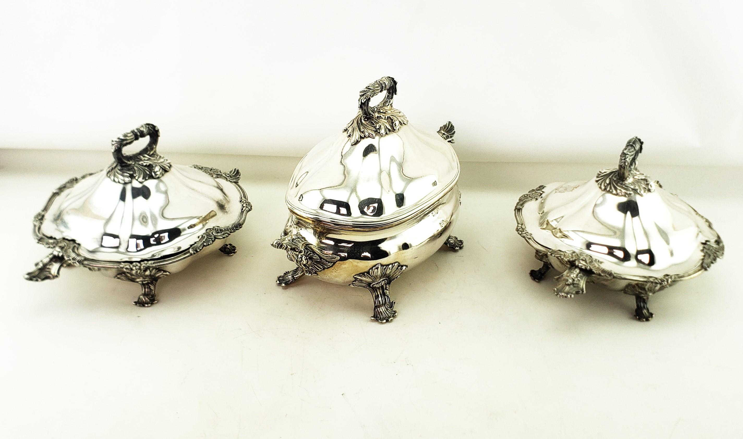 This set of three antique Sheffield plated covered tureens are unsigned, but presumed to have originated from England and date to approximately 1820 and done in the period Georgian style. These matching tureens are done in a heavy Sheffield plate
