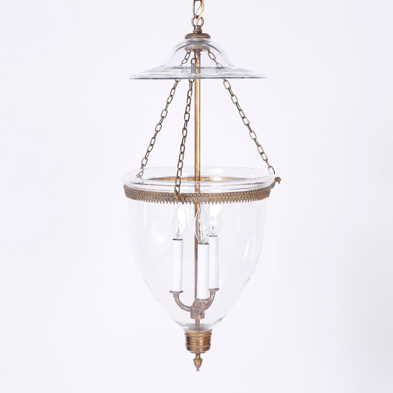 Refined set of three smoke bell light fixture with Classic form, hand blown glass, tooled brass hardware and phoenix bird chain hooks. Priced individually.