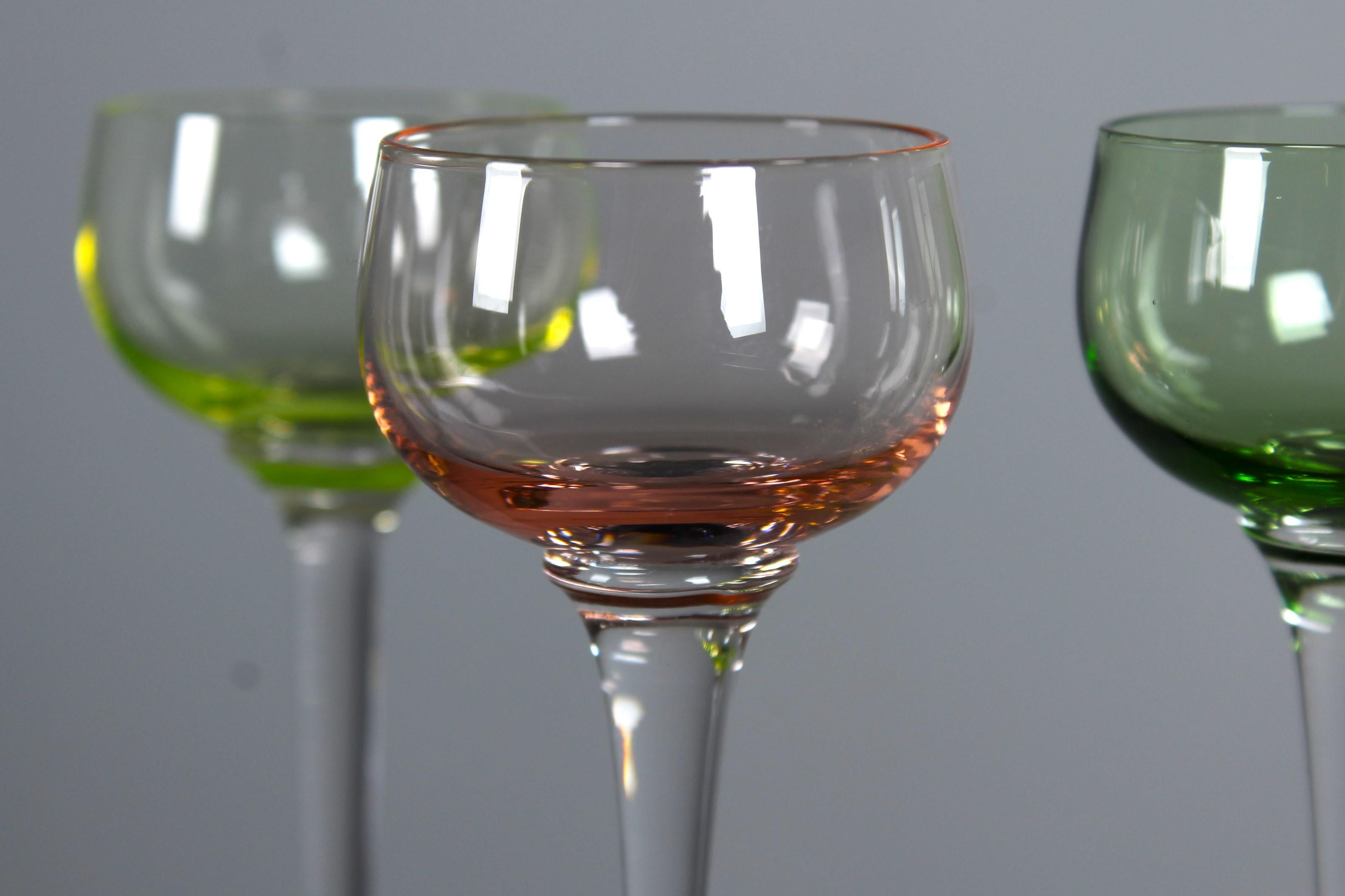 A beautiful set of three aperitif glasses in light green, rosé and dark green.