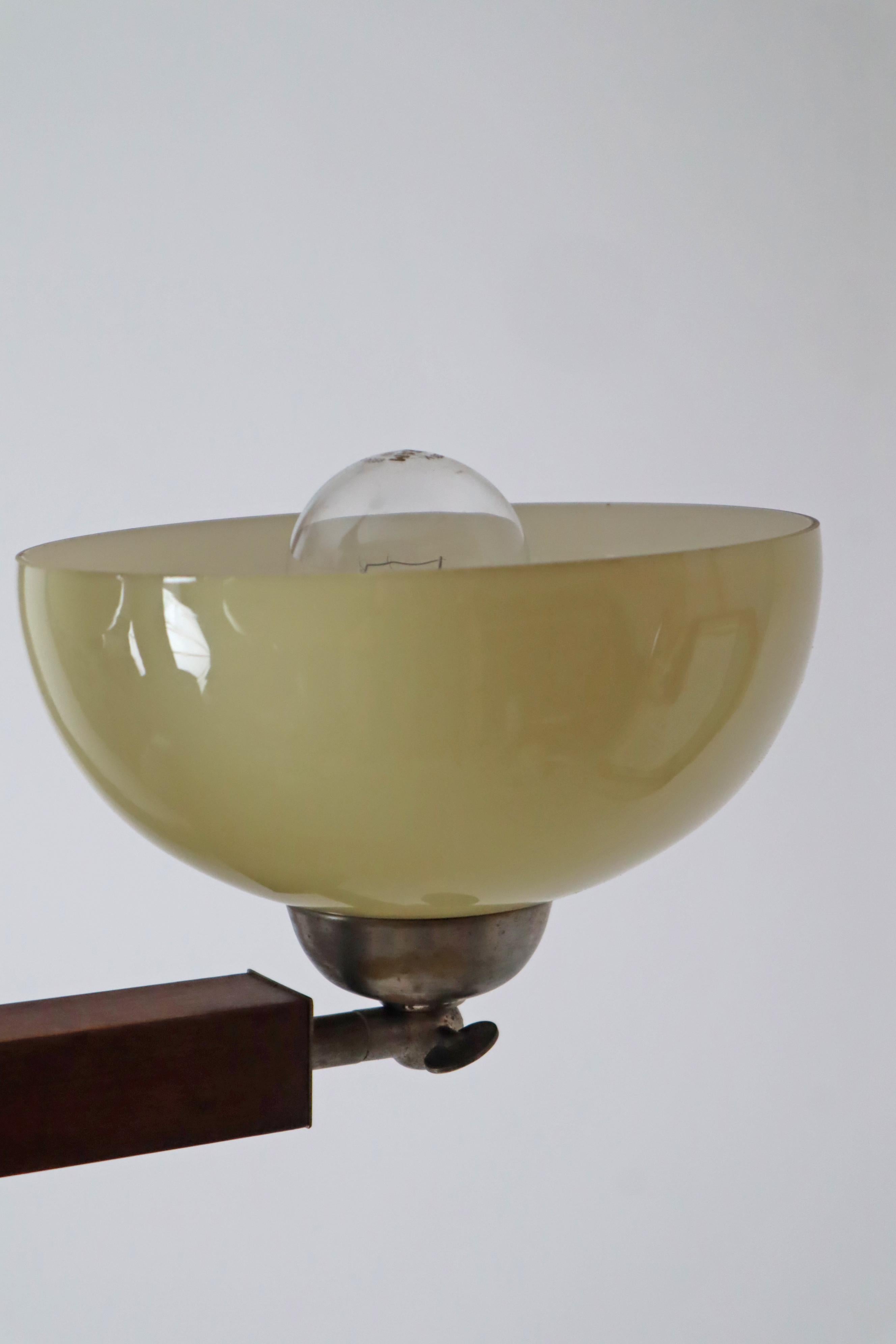 Look at this gorgeous Art Deco chandelier, it impresses with its simple, understated appearance, which was common at the time. You will be amazed when the light falls through the yellow and white light bowls and makes your room appear in a subtle,