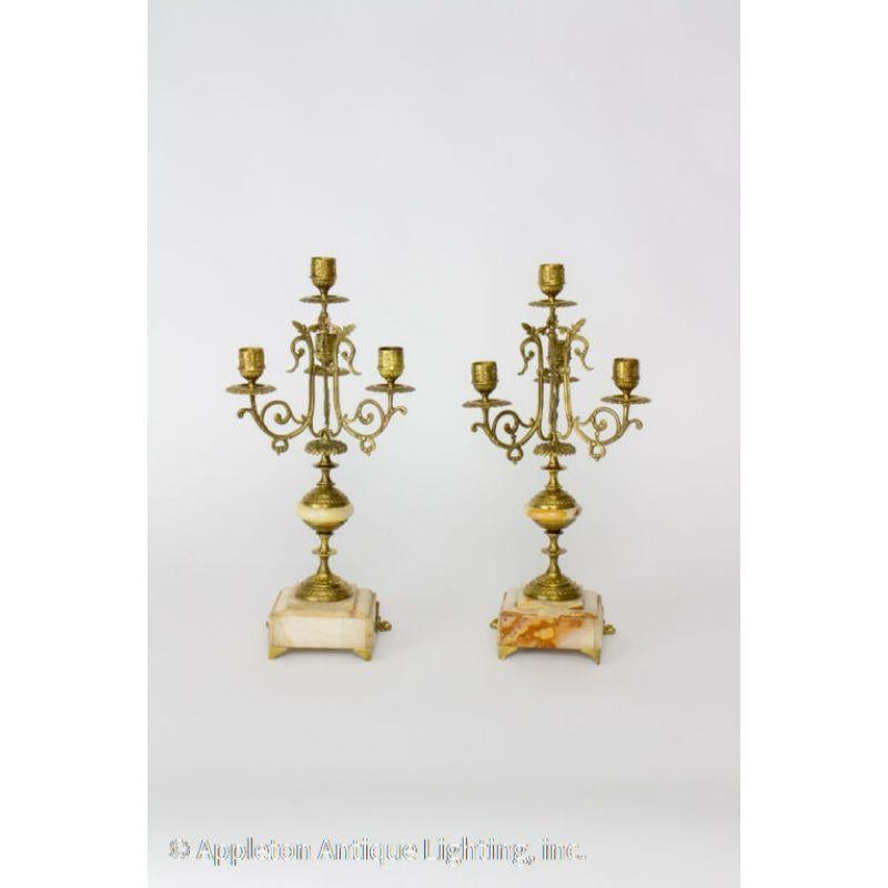 A pair of three arm brass candelabra with onyx bases. Ornate Victorian style. Includes original candle snuff

Material: Brass, onyx
Style: Victorian, Traditional
Place of Origin: United States
Period made: Mid 19th century
Dimensions: 8 × 8 ×