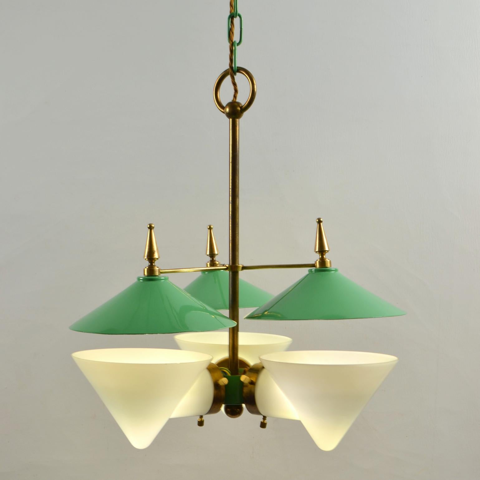 Extraordinary rare three arm 1950's French chandelier featuring a double conical shade made in two parts, the bottom part in opal glass and the cone shape reflector spun in classic 1950's green enameled aluminum with brass details and fixtures is