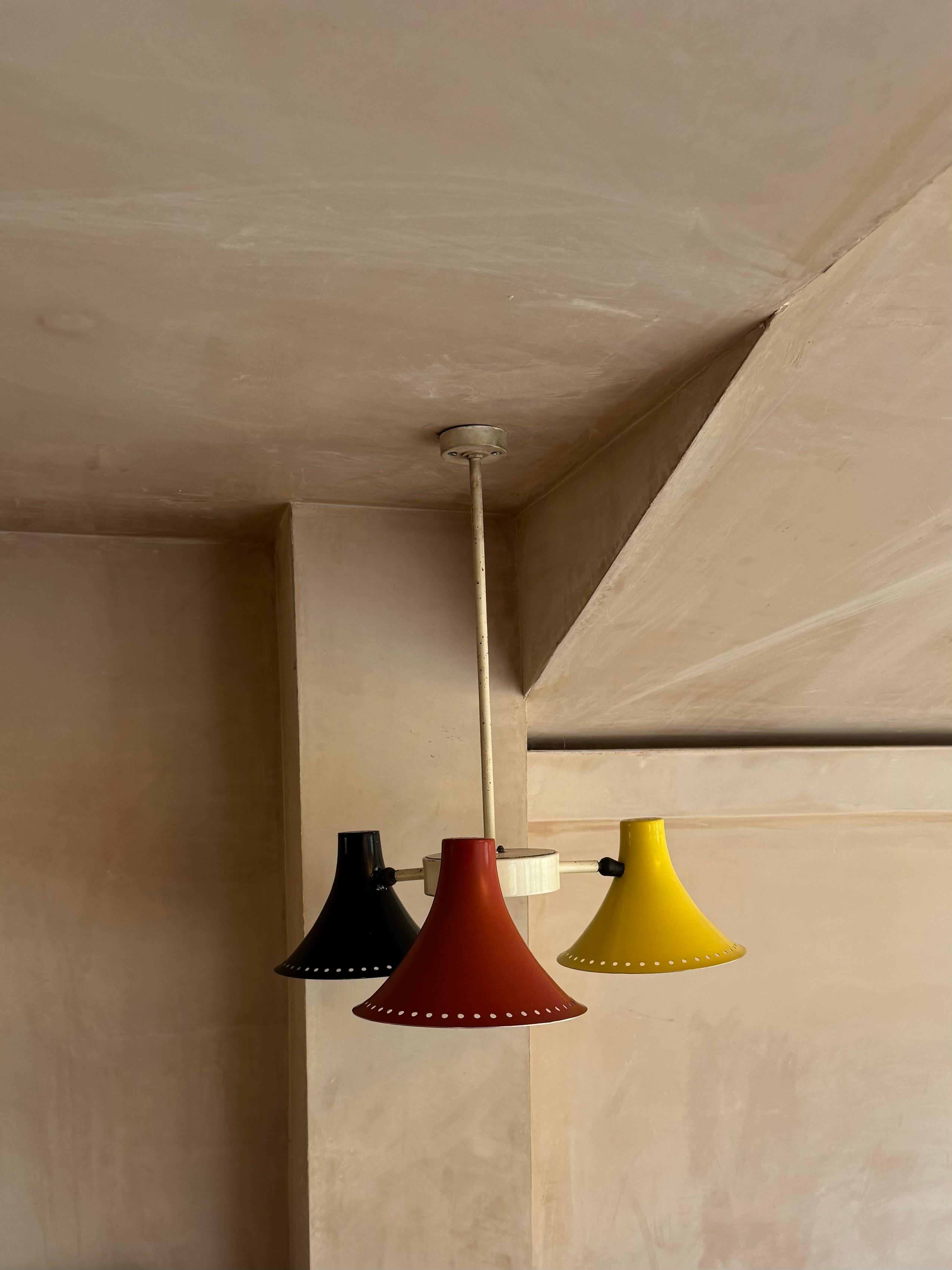 A fabulous red, black and yellow 1950’s ceiling light. Original paint colour to the shades. Some minor scratches and dents. Reminiscent of Bernard Schottlander. 