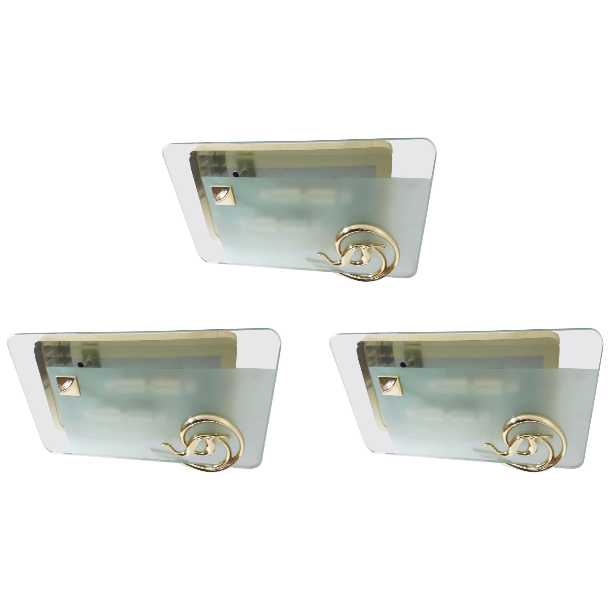 Vintage Italian wall lights or flush mounts with thick rectangular beveled glass diffuser mounted on gold plated solid brass frame, inspired by Fontana Arte, made by Fratelli Martini / Made in Italy, circa 1970s
4 lights / E14 type / max 40W