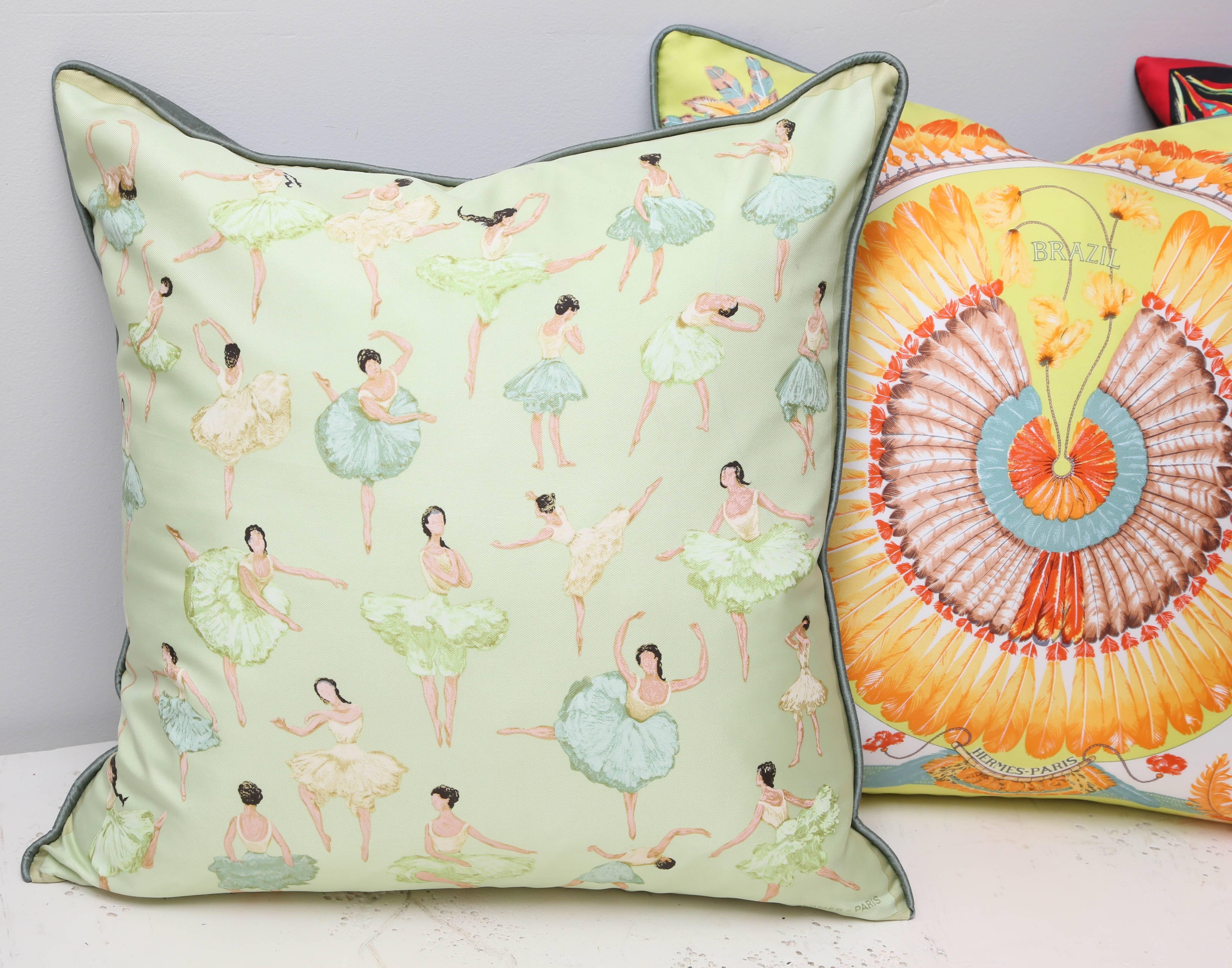 Three assorted vintage and colorful custom Hermes pillows.