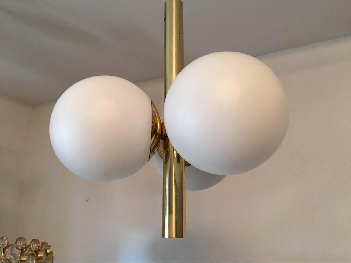 Copper and three milk glass ball pendants by Kaiser Leuchten of Germany. From the 1970's. Very nice lighting effect. The fixture requires three European E14 candelabra bulbs, each bulb up to 40 watts. In good working condition. Equipped with