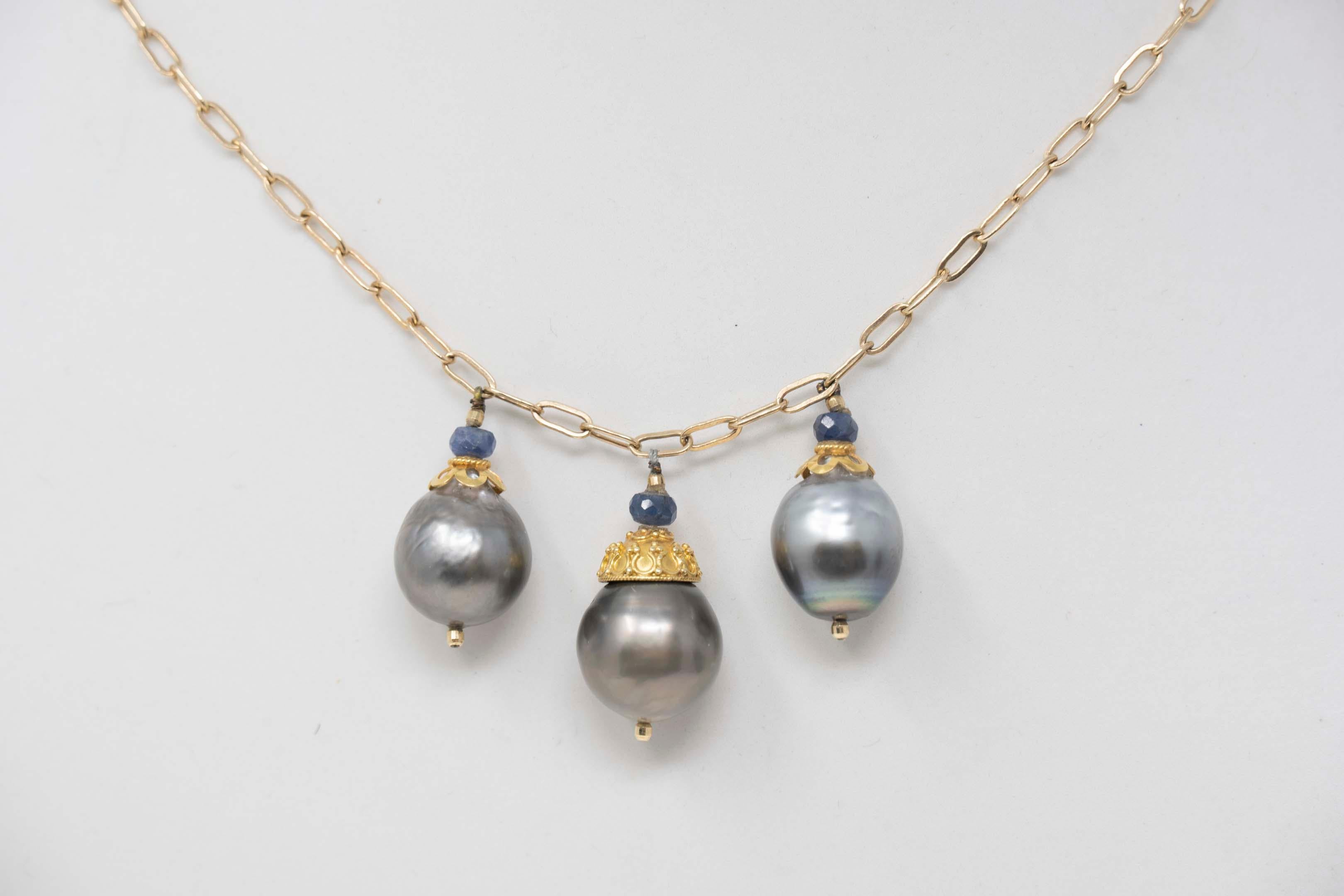 One (1) ladies necklace in yellow 14 karat (stamped), fantasy style, polished finish. Total weight 17.5 grams. The item is set with three (3) baroque cultured Tahiti pearls. Measures 12-14mm in diameter. Primary color: gray. Nacre thickness: thick