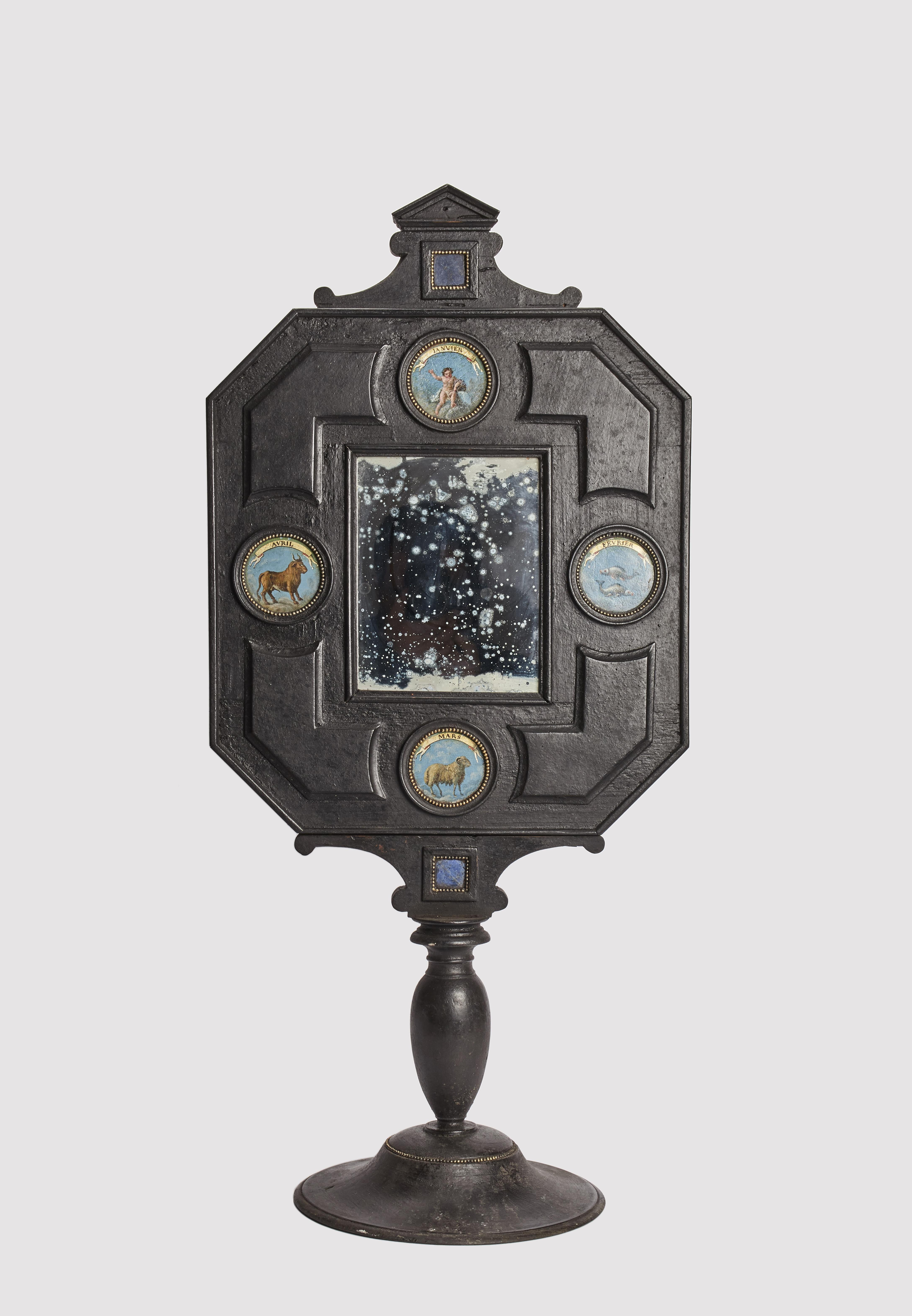 A Wunderkammer three big mirrors with a black octagonal wooden frame, with 2 lapis lazuli embedded in a frame, mounted over a black round wooden base. Each mirror contains 4 round inserts depicting different zodiac signs, painted oil on leather,