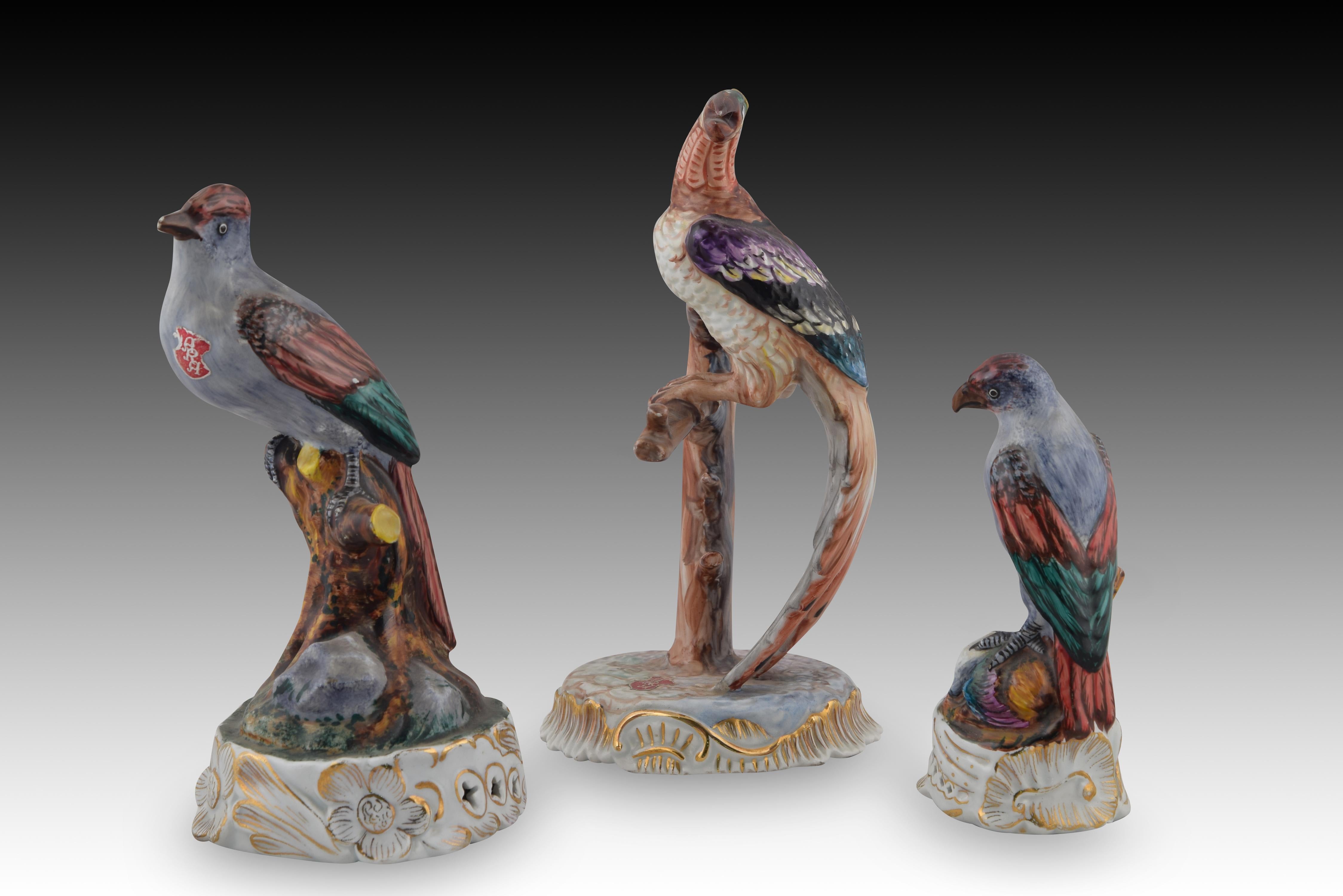 Three birds. Enameled porcelain. Possibly ARA Manises, Valencia, Spain, 20th century. 
Marks on the base. 
One has traces of label. Three birds, different from each other, appear perched on stumps and rocks in each of the three enameled porcelain