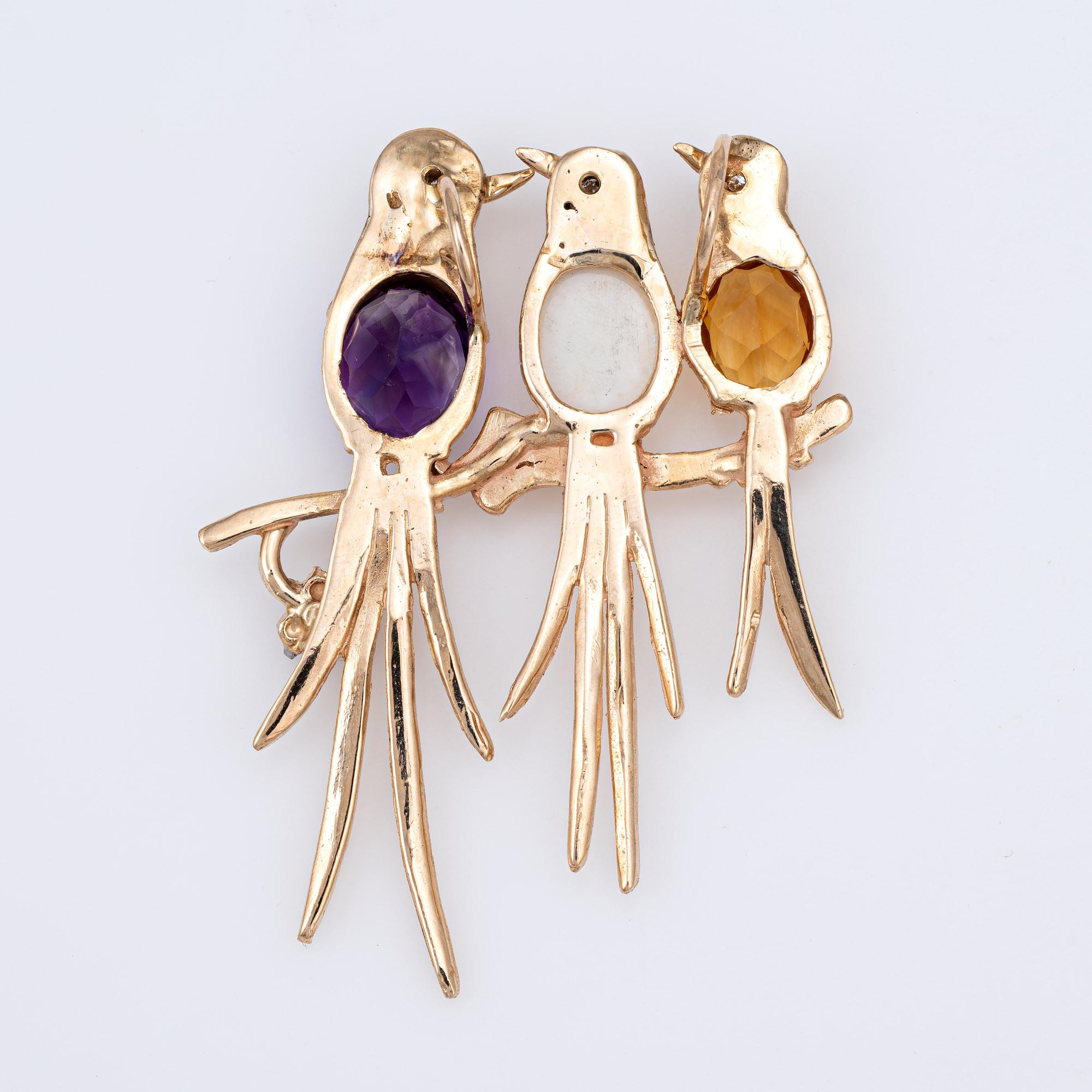 Finely detailed vintage pendant featuring three birds on a branch (circa 1960s to 1970s) crafted in 14 karat yellow gold. 

Amethyst, citrine and opal range in size from 2 carats to 2.50 carats. Diamonds total an estimated 0.10 carats (estimated at