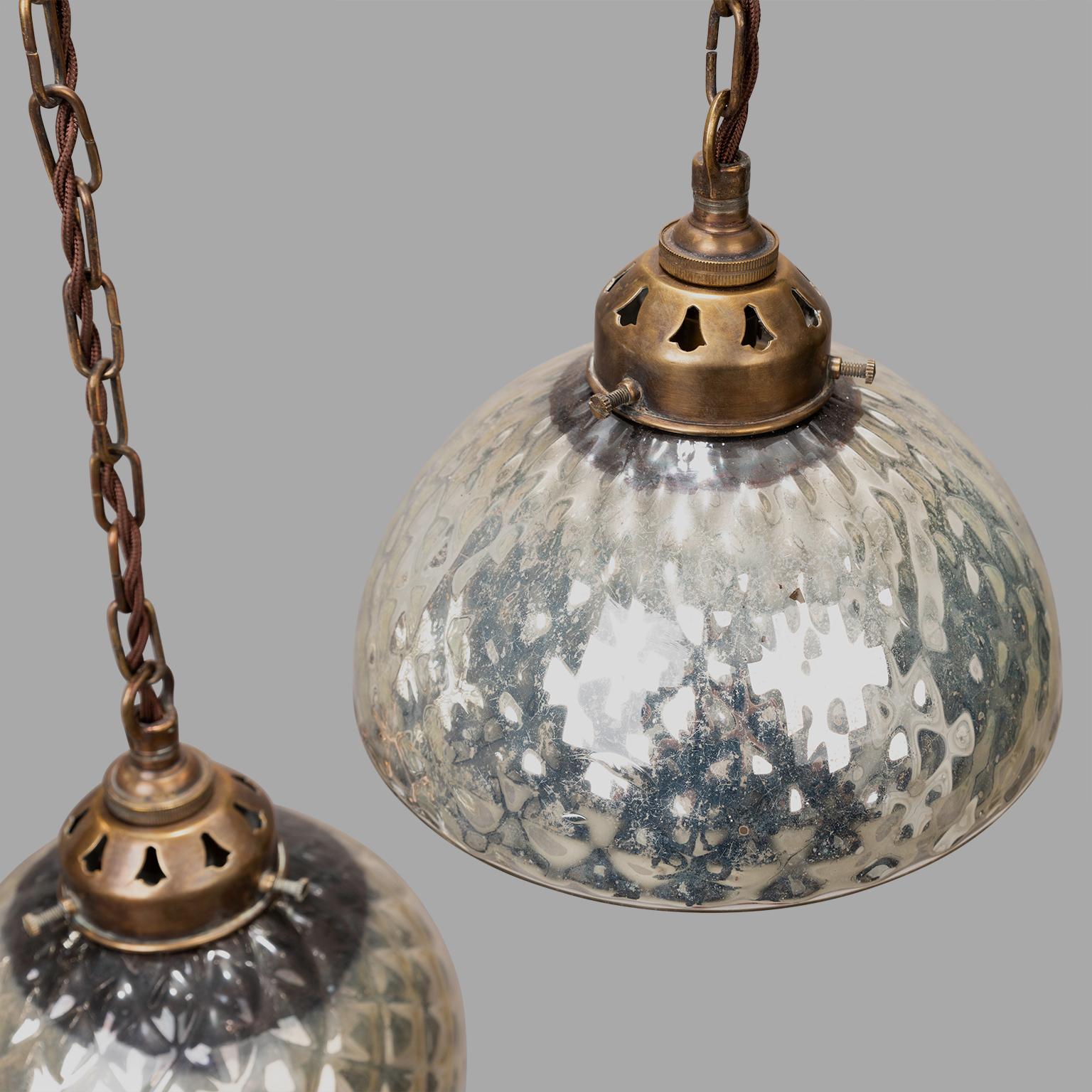 Originally used as lamp reflectors, we are seduced by the mirror aspect inside and outside of these globes which have been mounted on brass. Contemporary wiring with E27 sockets.

Measures: Two are of identical diameters, one is slightly smaller: