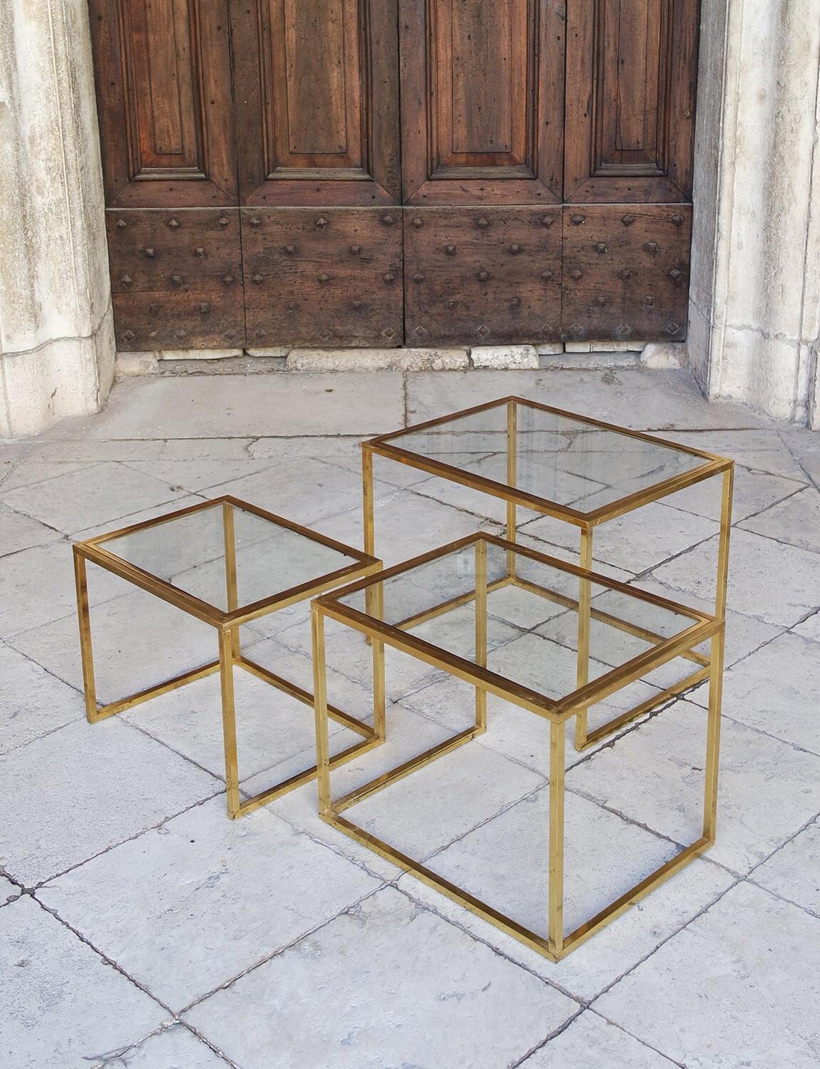 A set of three 1970s elegant brass side tables which nest beautifully one inside the other. They each have a glass top. The brass is in good condition but there are signs of age as evidenced in the detailed photographs.

Dimensions: Large H46cm X
