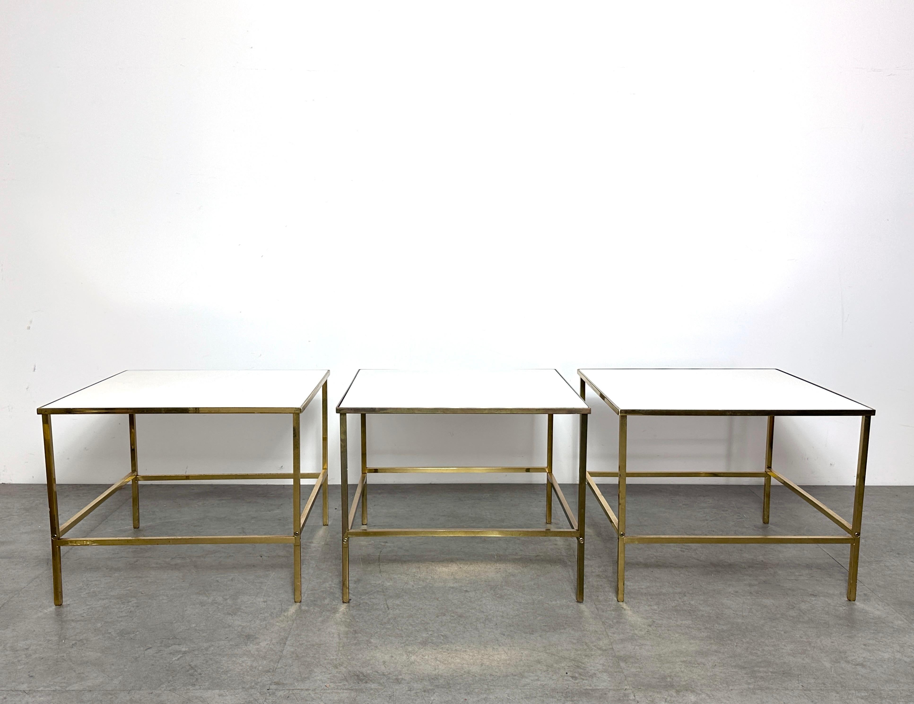 Three matching square side tables or modular coffee table by Harvey Probber circa 1950s

Elegant and clean design with solid brass frames and inset Vitrolite surfaces
Suitable as side tables or placed together as a cocktail table

Please inquire for