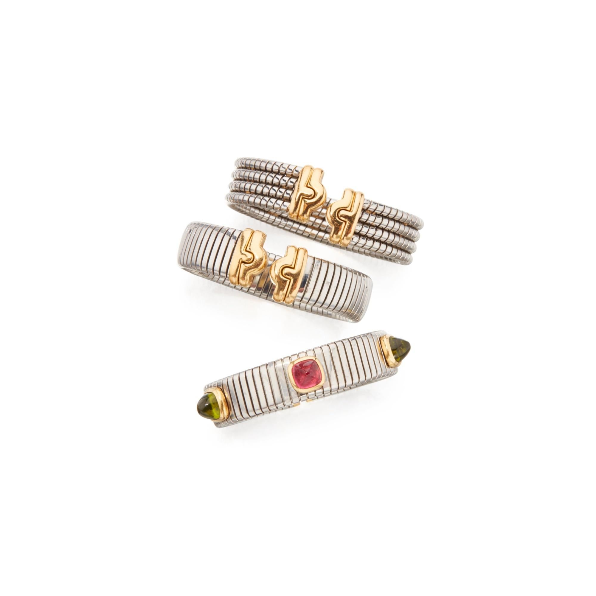 Three Steel and Gold ‘Tubogas’ Bracelets by Bulgari
Each of sprung design, two with decorative gold terminals, one with the inscription and a third featuring a pink tourmaline sugarloaf cabochon and two similarly-cut peridots, internal circumference