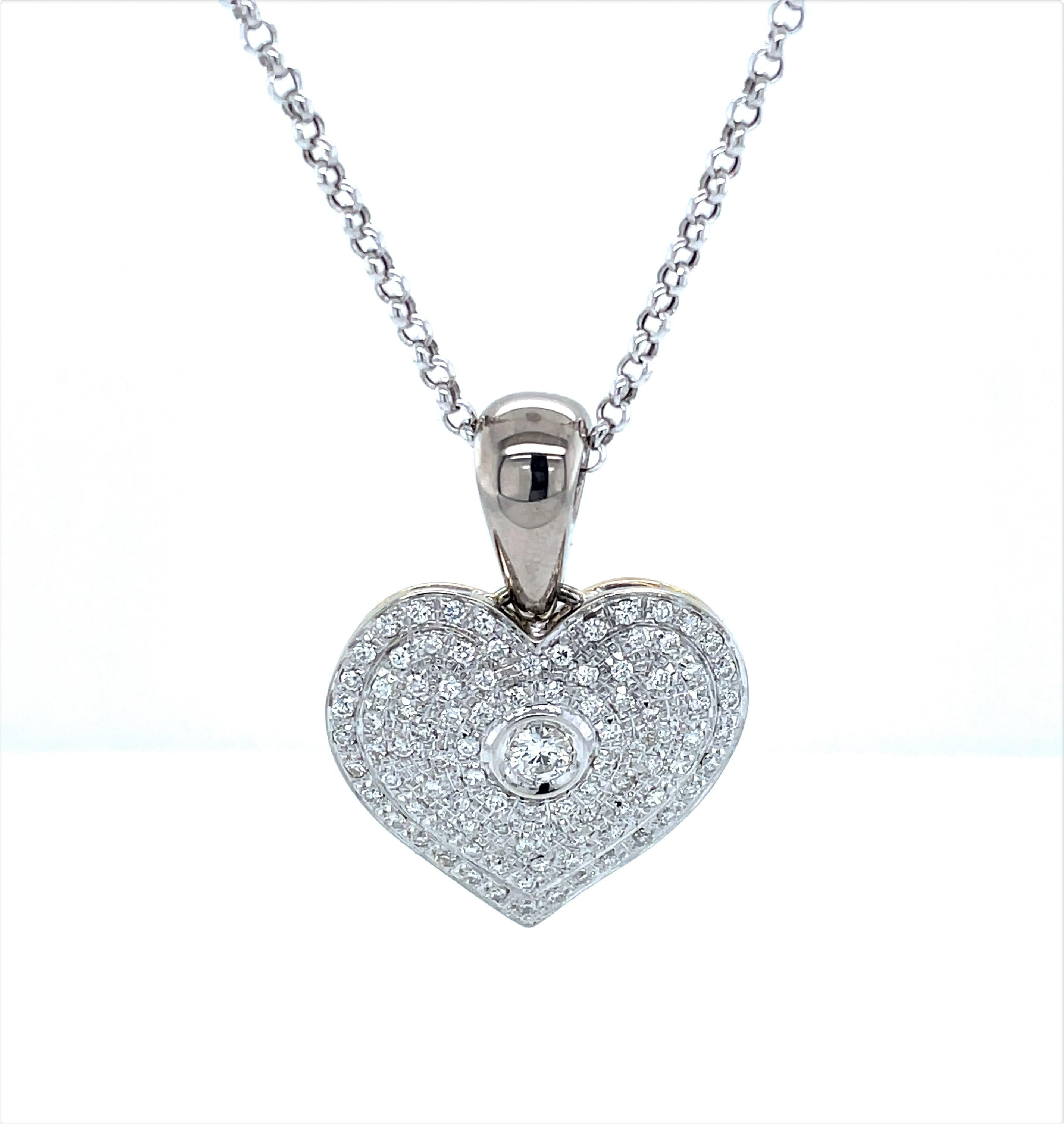 Show your love with this endearing diamond illuminated keepsake 18 karat white gold heart pendant necklace. With over three carats of full cut round H/VS diamonds, 3.10 TW, the pendant boasts one center .10 carat bezel set round faceted diamond and