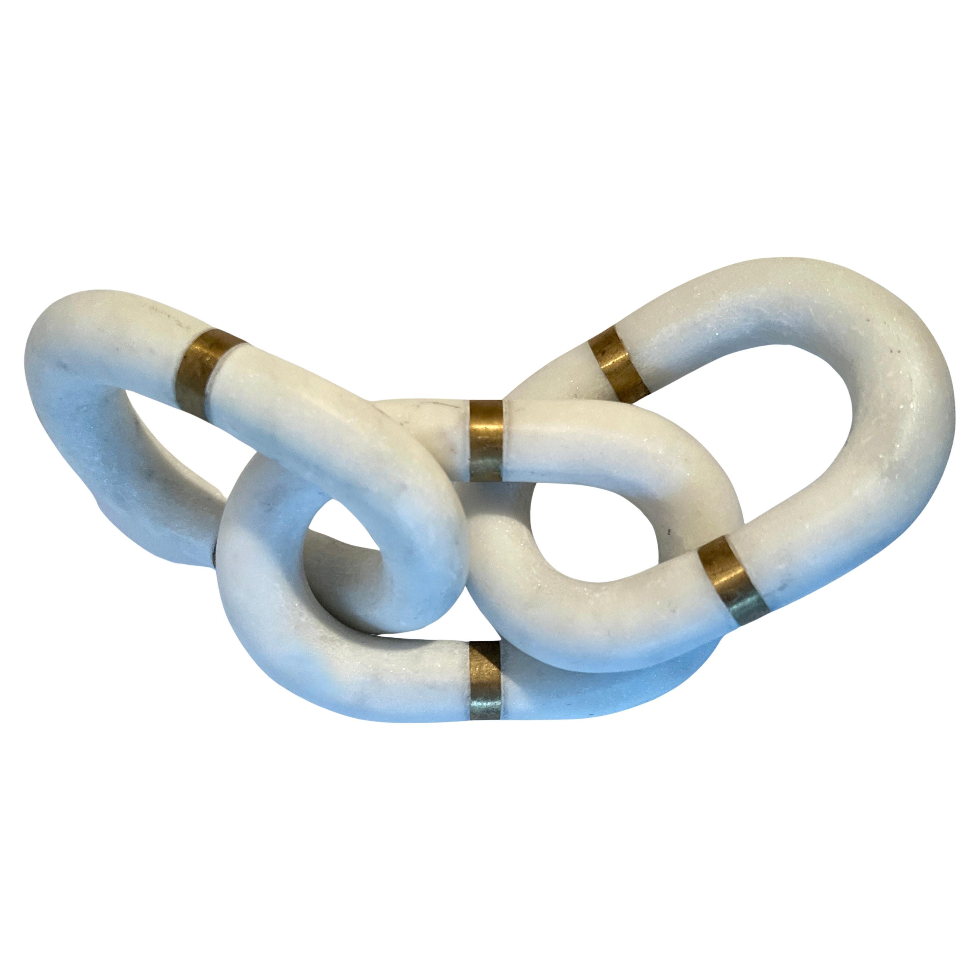 Our newest favorite pieces - Three interlocking hand-carved marble links with a brass detail on each one.  The trio make a great sculptural decorative detail, or can also be used as paperweights.  A really stunning look of over sized links.

The