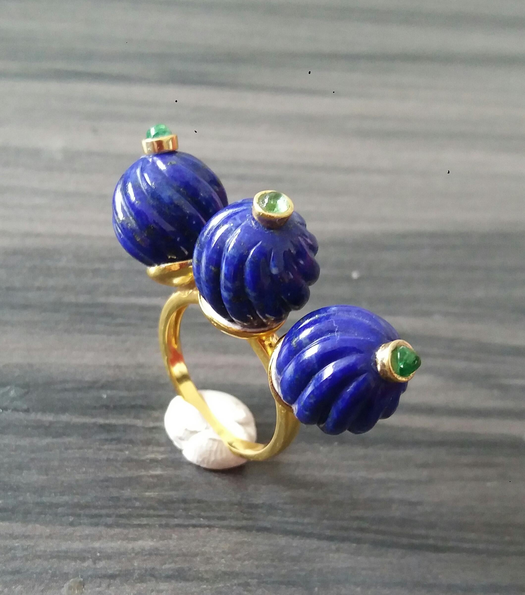 Unique and Classic Cocktail Ring composed of 3 engraved spheres of Lapis Lazuli of 12 mm. in diameter surmounted by 3 small Emerald cabochons set in yellow gold bezels,all set on a 3 cup yellow gold shank.
In 1978 our workshop started in Italy to