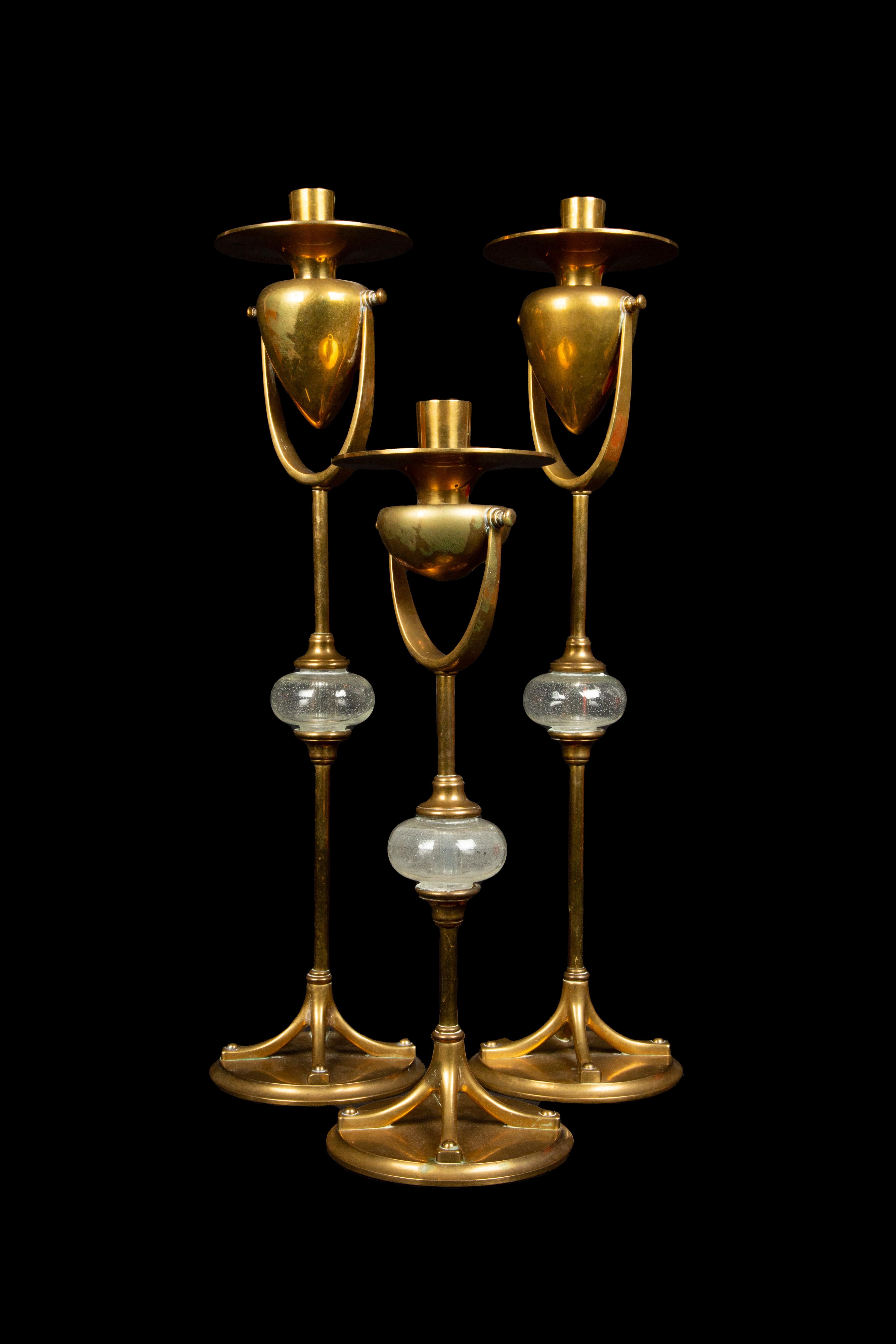 Inspired by the timeless elegance of the Tiffany model 1213 Art Nouveau candlesticks, these Chapman candlesticks truly embody magnificence. Meticulously crafted, these candlesticks boast a strikingly tall scale and a solid brass construction that