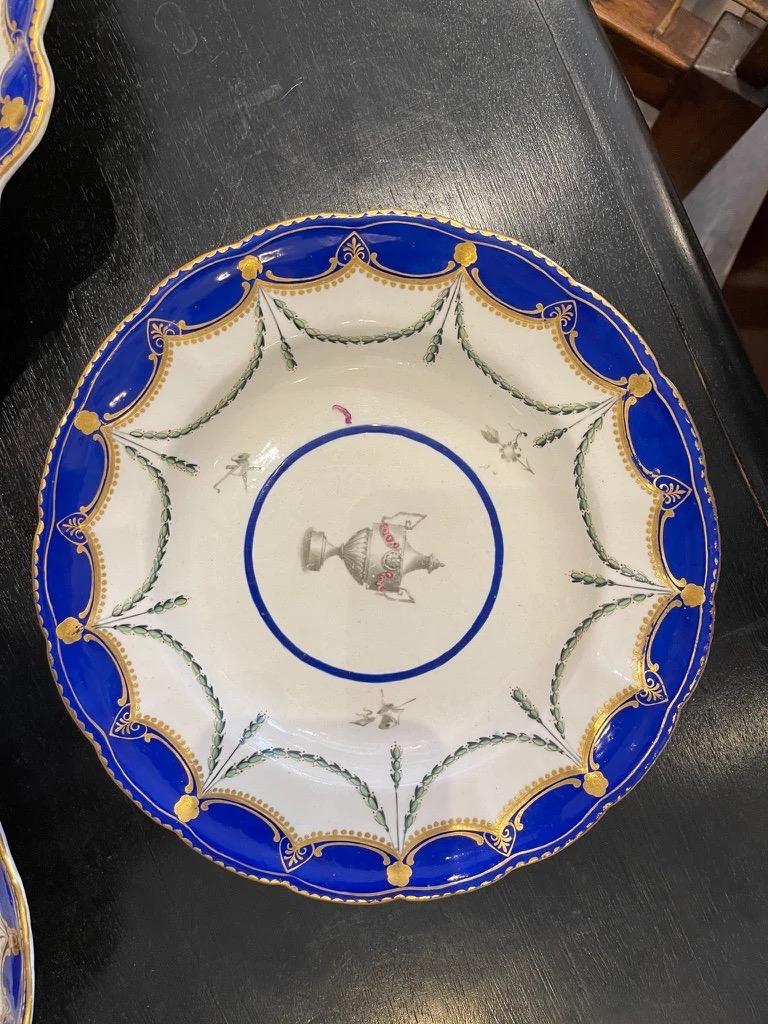 Three Chelsea-Derby porcelain pieces, circa 1775. Central urn cartouche flanked by musical instruments having a cobalt border and gilt accents. The two serving pieces with of scalloped form. The largest dish is 2.75” H x 12.5” W x 10.25 D, the