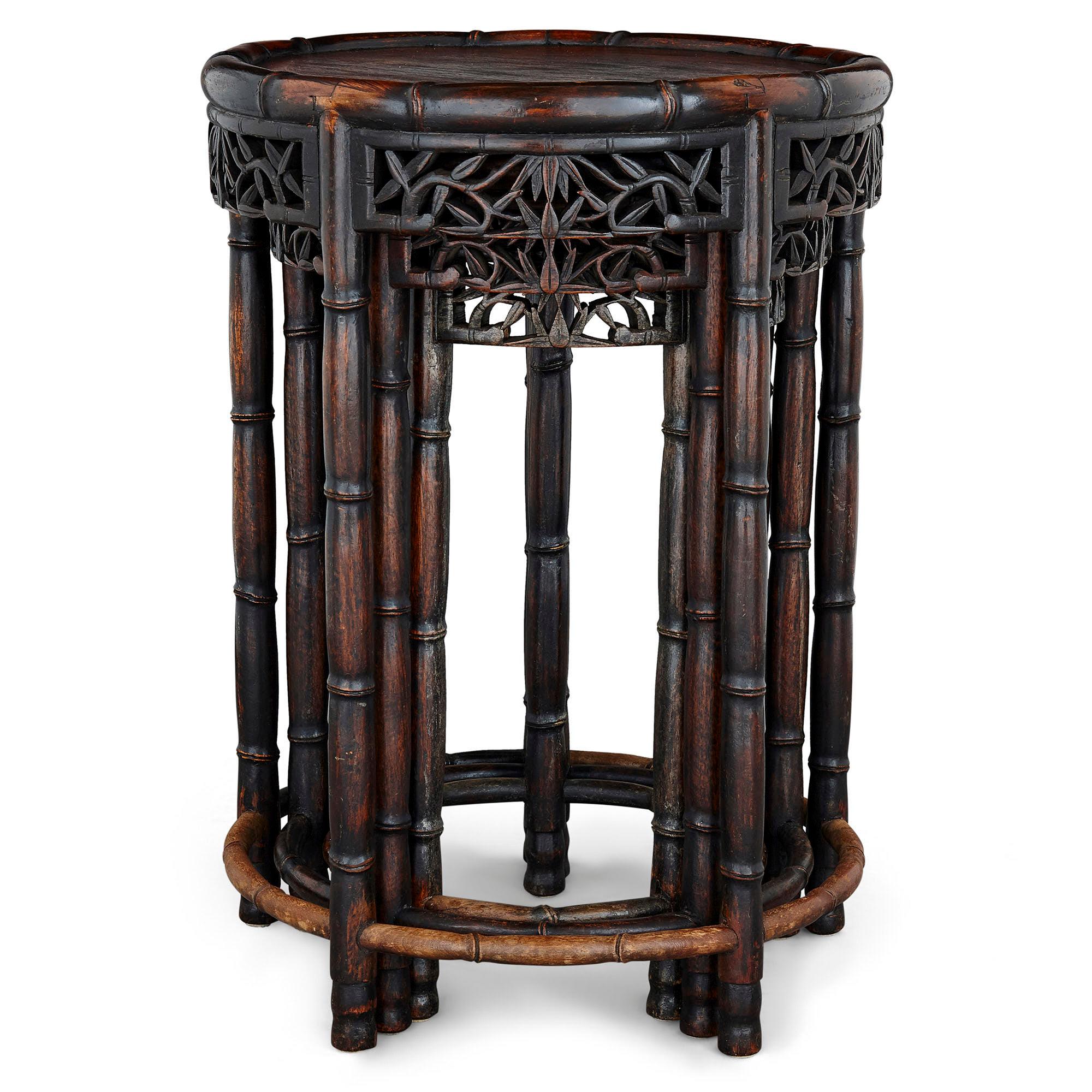 Three Chinese hardwood nesting tables
Chinese, early 20th Century
Largest: Height 58cm, diameter 41cm
Smallest: Height 51cm, diameter 28cm

The hardwood nesting tables in this set of three are carved in imitation of bamboo. Each table features