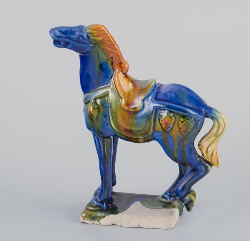Pre-owned goods are exempt from import duties for U.S. customers. 
Therefore, no import tariffs will be applicable to your purchase.

Three Chinese Tang horses in earthenware.
Hand-glazed in shades of brown, blue, and green.
Circa