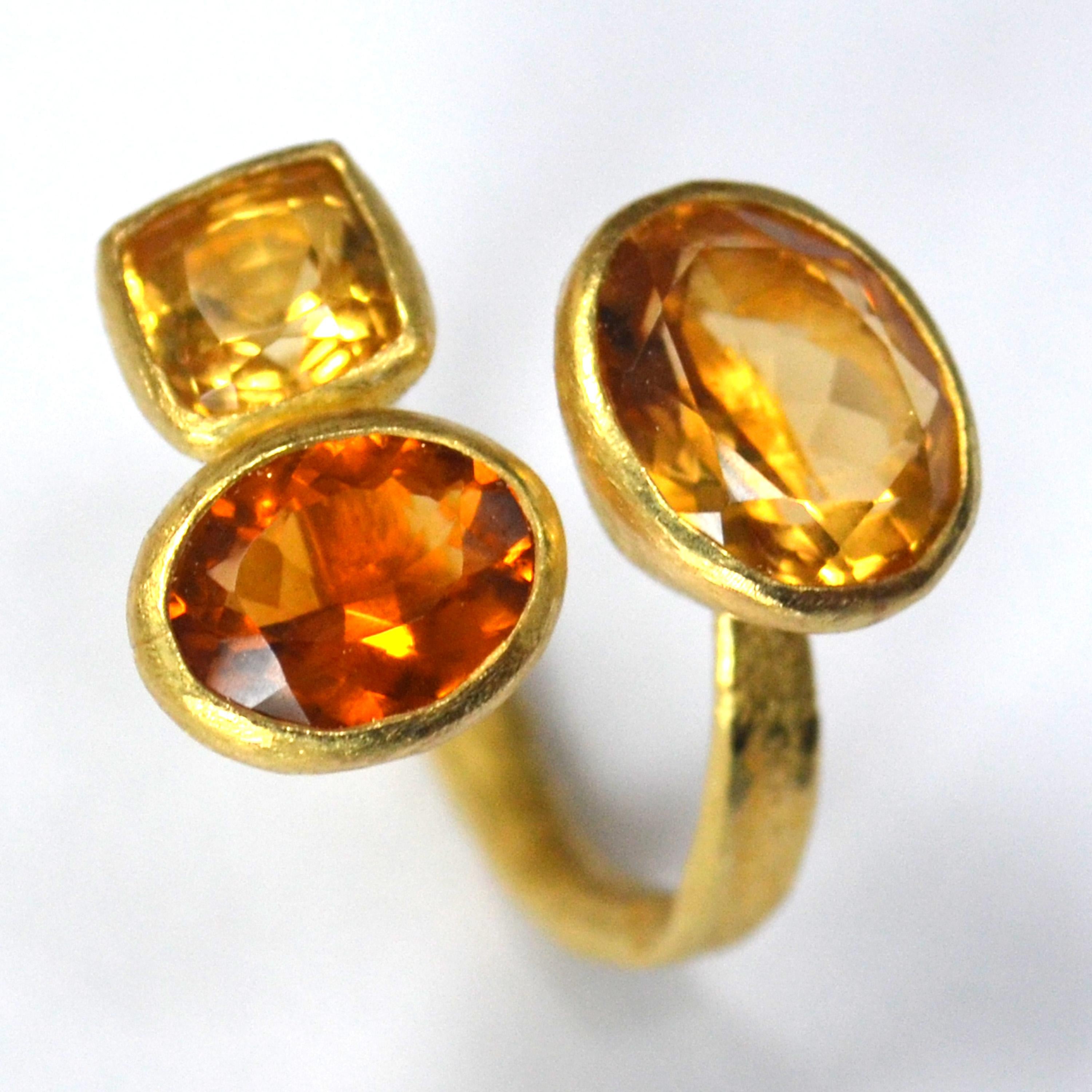 18k yellow gold reticulated texture open ring with three citrines:
x1 oval 5 carat golden citrine
x1 cushion cut 2 carat golden citrine
x1 oval 3 carat madiera citrine.

This ring is handmade by London goldsmith Disa Allsopp, known for her organic