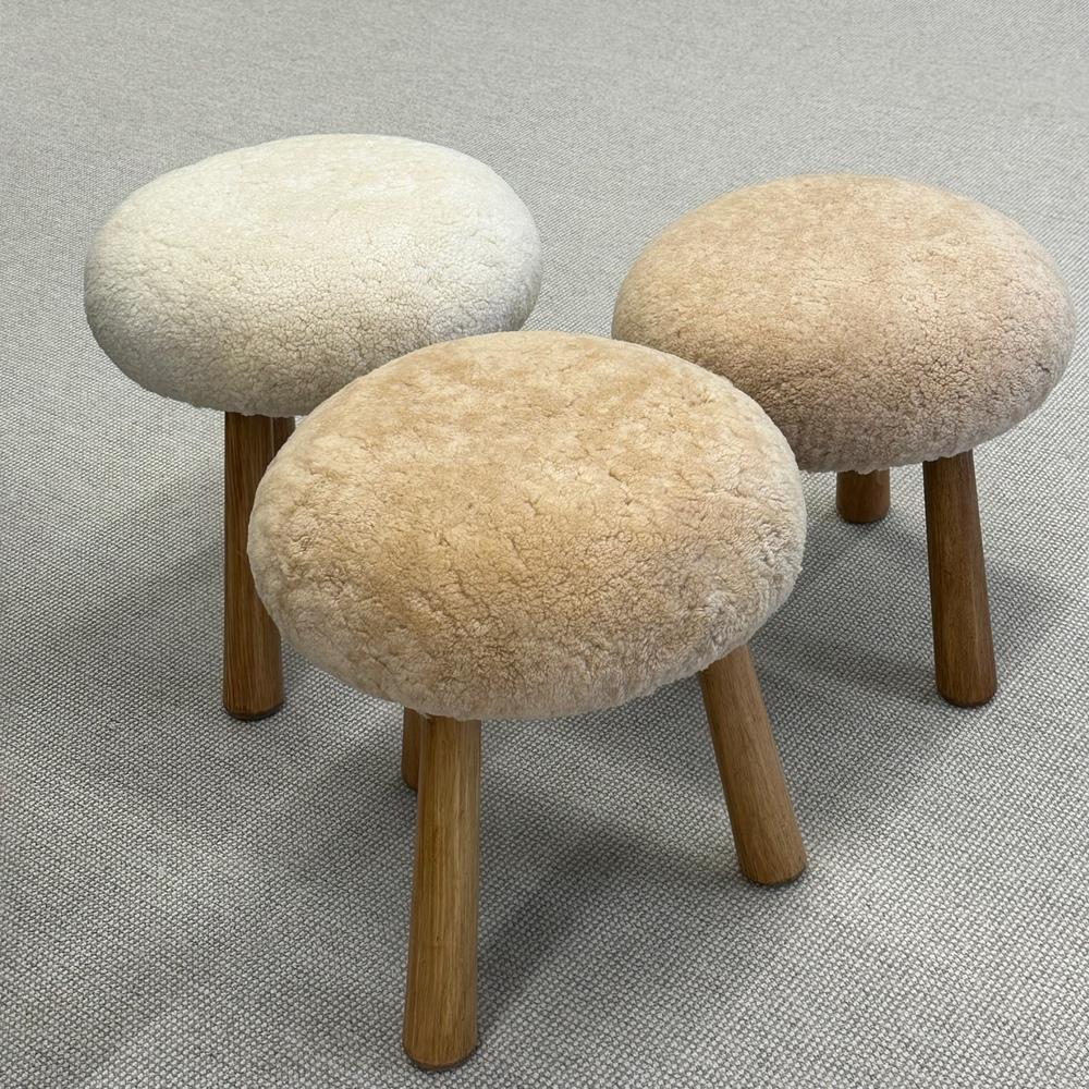 Three Contemporary Scandinavian Modern style sheepskin stools / ottomans

Contemporary organic form tri-pod stools or ottomans. New memory foam cushioning and genuine shearling. Three stools in total - two of which (nesting) are upholstered in a