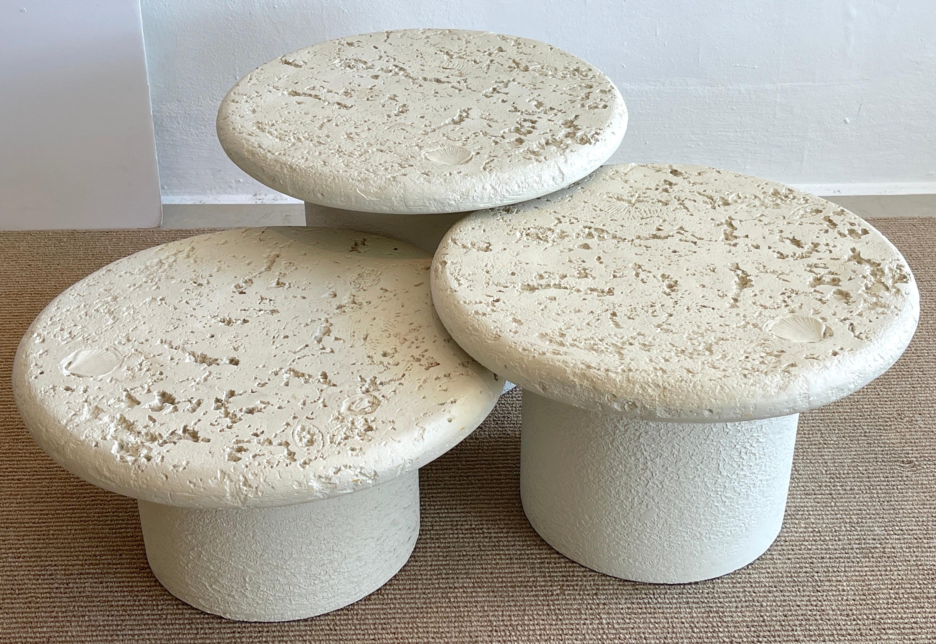 Three coquina stone style tiered tables, C. 1970s
Each one with realistically cast composition and plaster to resemble coral and shells.
Each top has 21.5-Inch diameter, the heights are 21