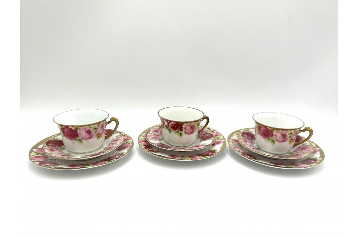 Three breakfast sets consisting of a cup, saucer and plate

White porcelain with a motif of Chrysantheme Cacilie roses

Produced in the Porcelain Factory in Stanowice near Strzegom (formerly Stanitz)

Signed with the mark used in the years