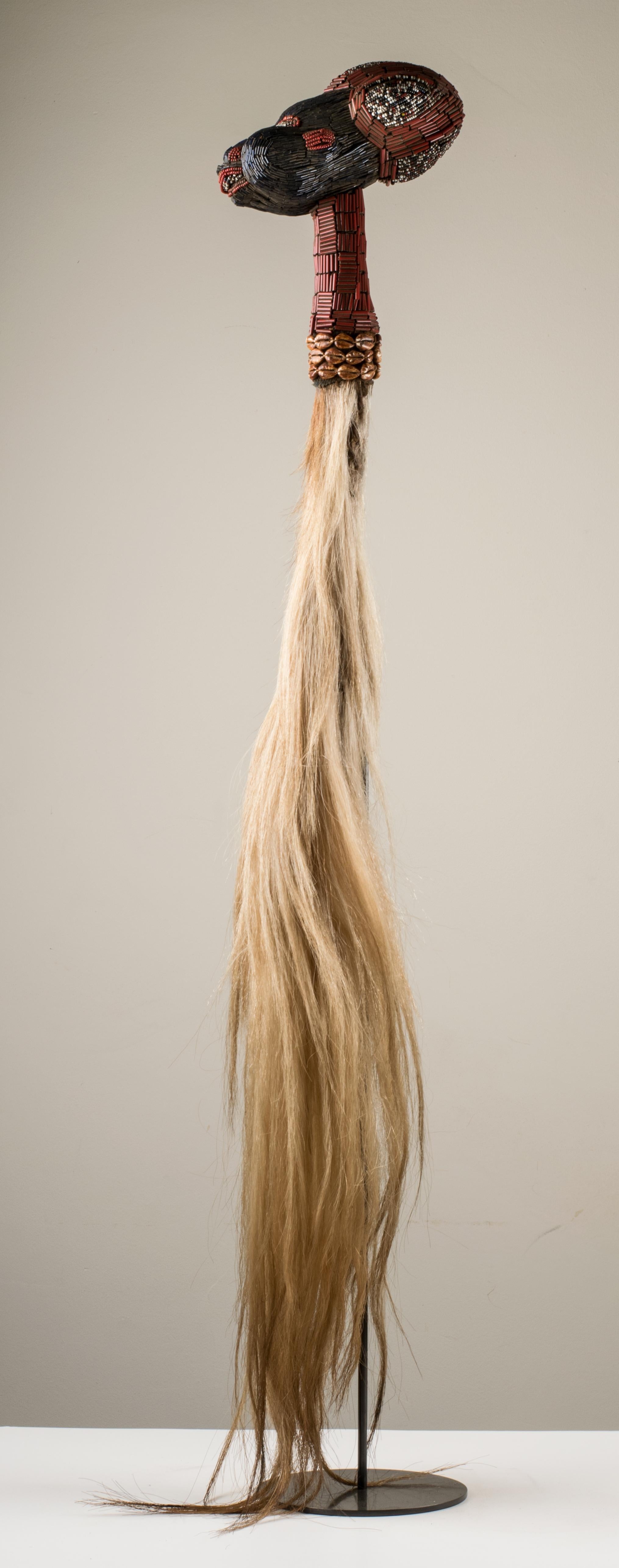 The Royal Fly Whisks (ethnic names: see leng koko or beuka) used in dances are made of carved wood to which horse tails are attached. These tails are veritable war trophies cut from horses killed in battle against and amongst the Bamoum, Fulbe and