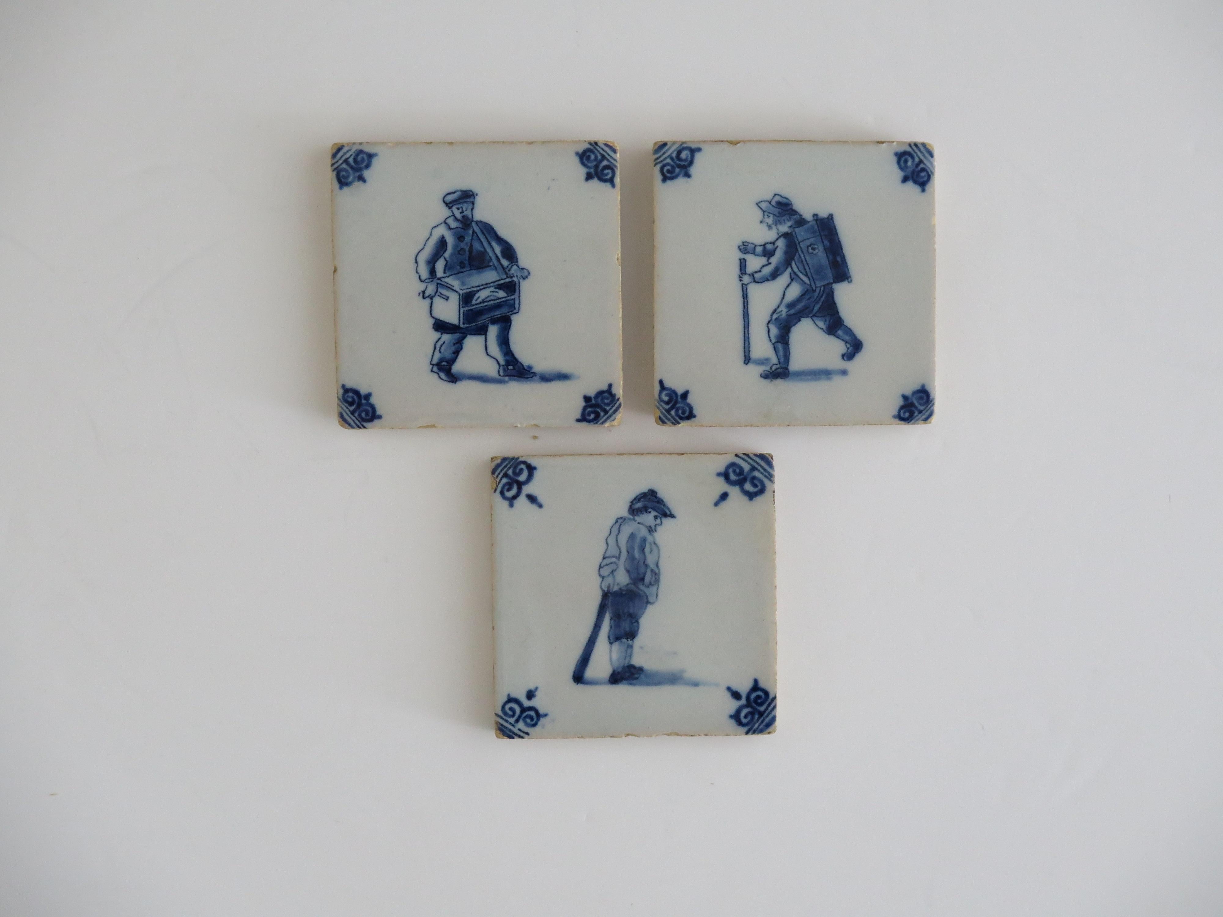 These are a very decorative set of Three small ceramic wall tiles, with a Blue and White figural scene, dating to the later part of the 18th century or early in the 19th Century.

All three tiles are nominally 3 inches square and 3/8 inch