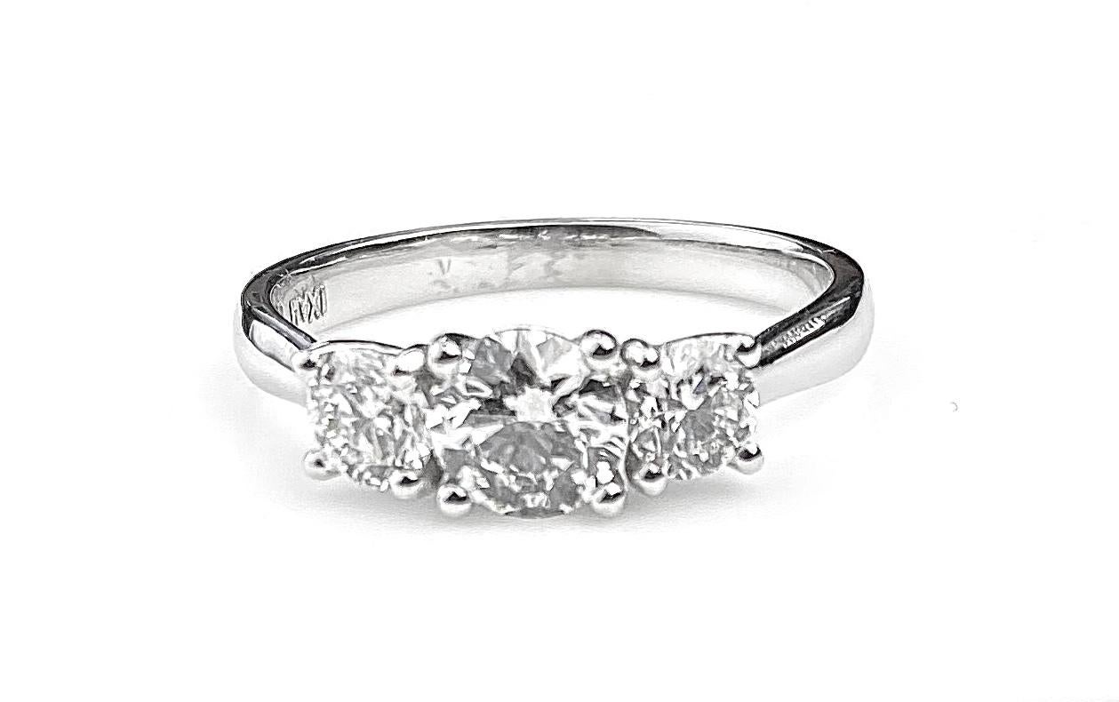 Three-diamond ring with 0.60ct centre diamond, F VS1 GIA# 2177171699, and two side diamonds totaling 0.51ct. Side diamond quality F/G colour and VS/SI1 clarity. Current ring size 6 1/2. Complementary resizing up or down two ring sizes.