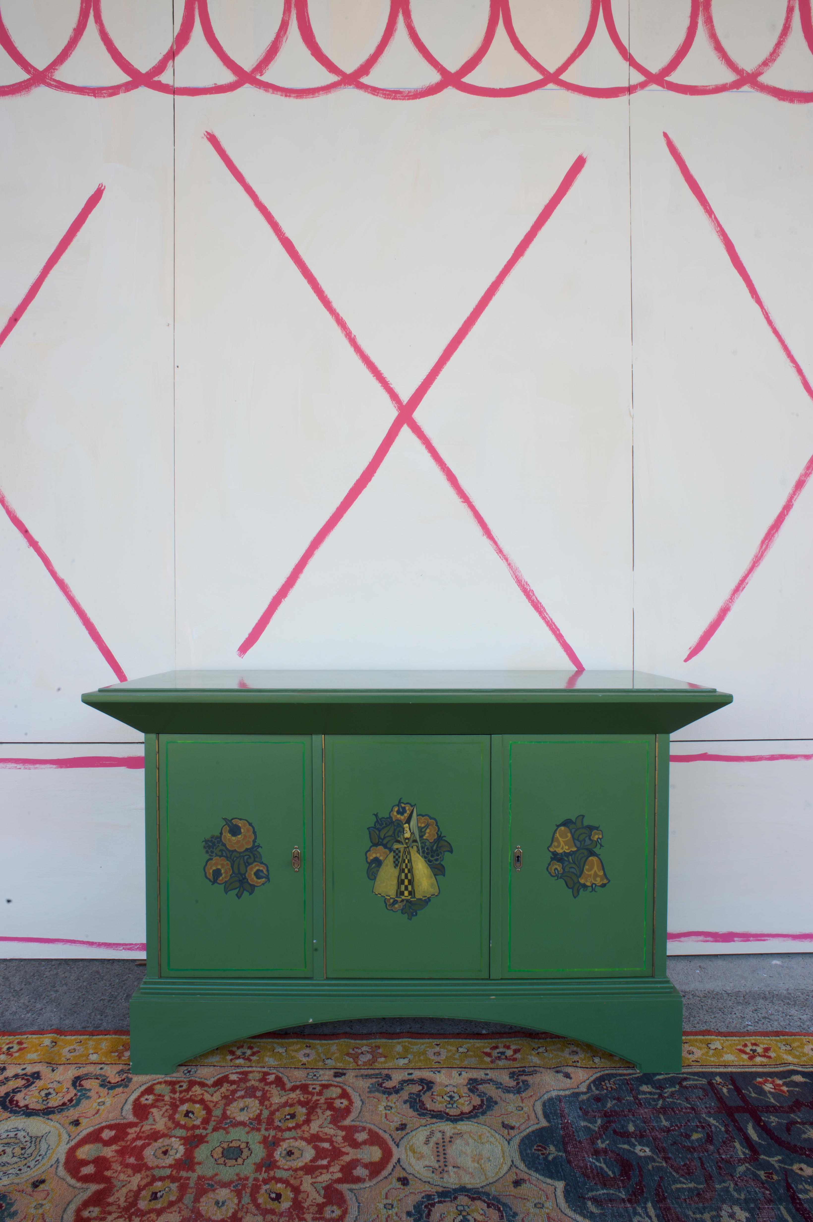 An exceptional three-door lacquered cabinet attributed to Max Wiederanders, Munich, circa 1919, demonstrating the distinctive aesthetic dialogue between medieval imagery and the influence of the Wiener Werkstätte that characterized progressive