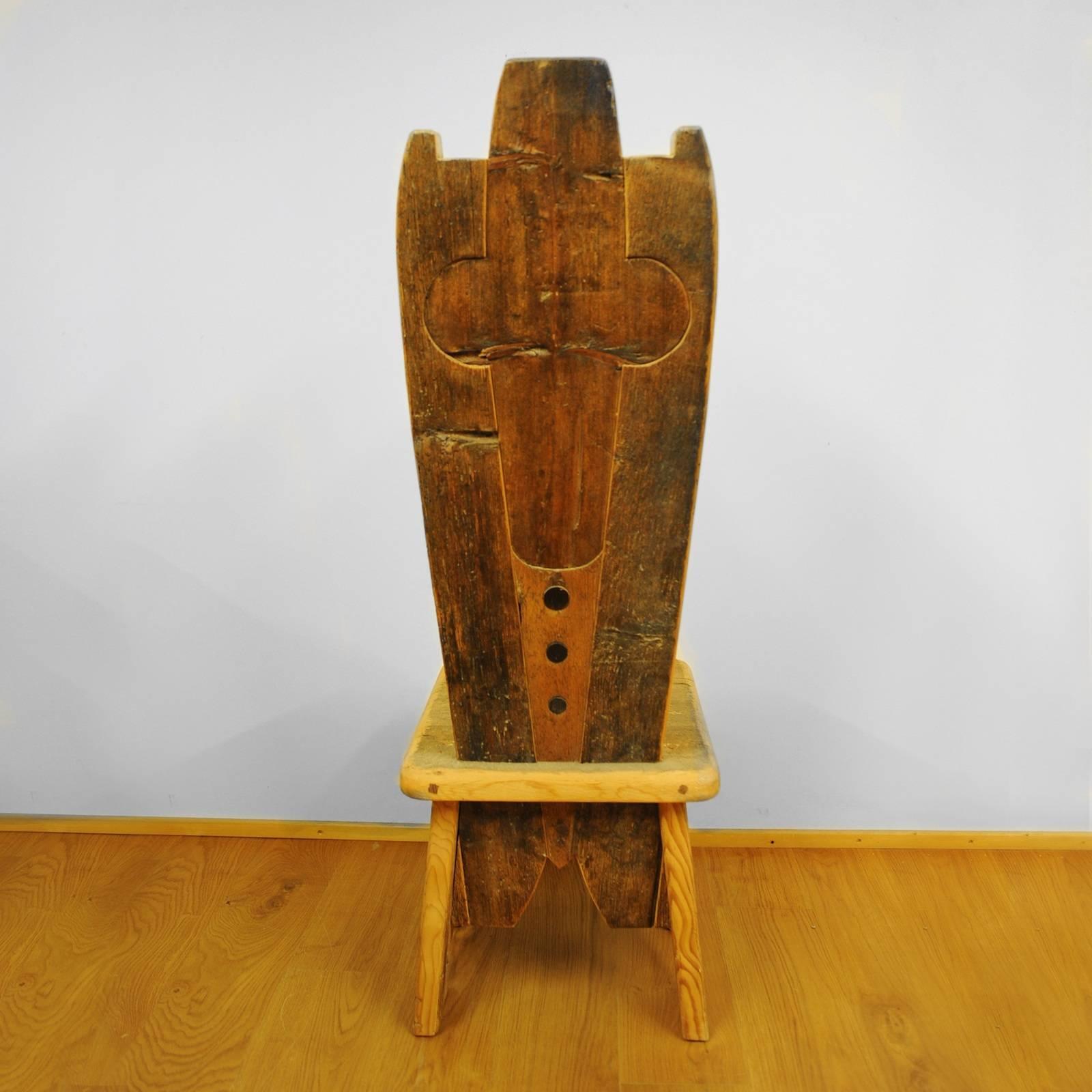 A stunning piece of functional decor, this chair is part of the Throne collection, featuring 20 designs that boast a throne-shaped backrest. This chair is crafted using larch, pine, fir, and Swiss pine sourced from old 16th century homes. The