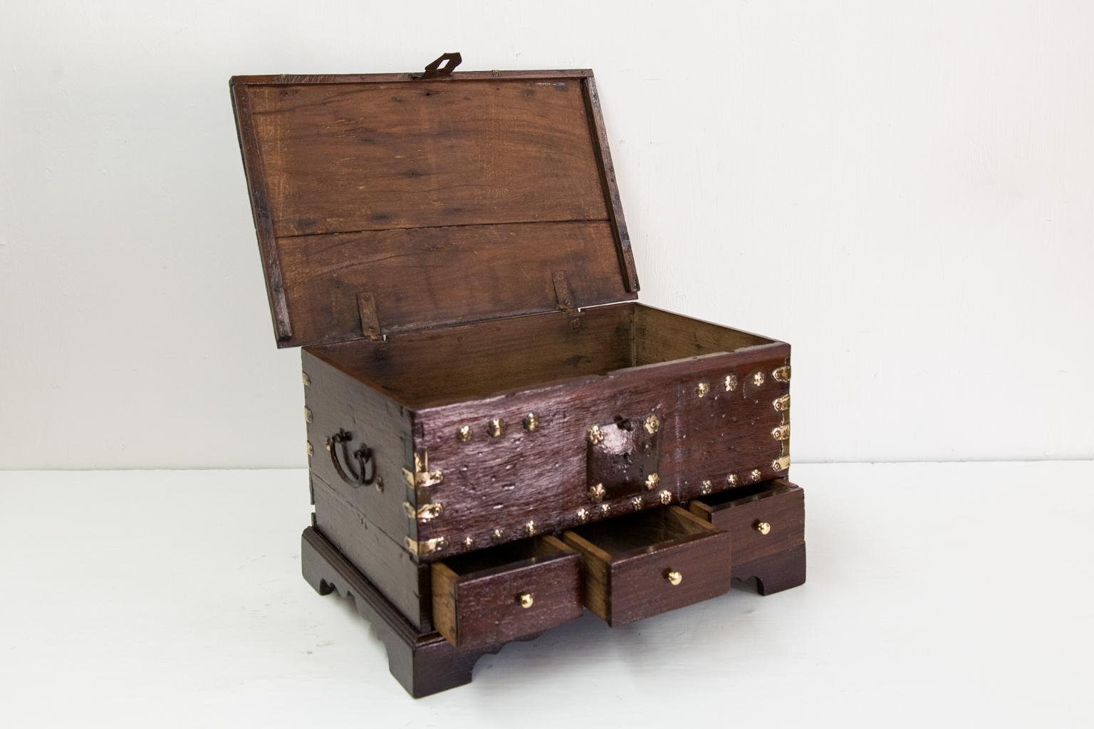 Three-drawer brass bound chest, with the original steel hasp and carrying handles, with brass bound corners and decorative brass stud work on the front.
