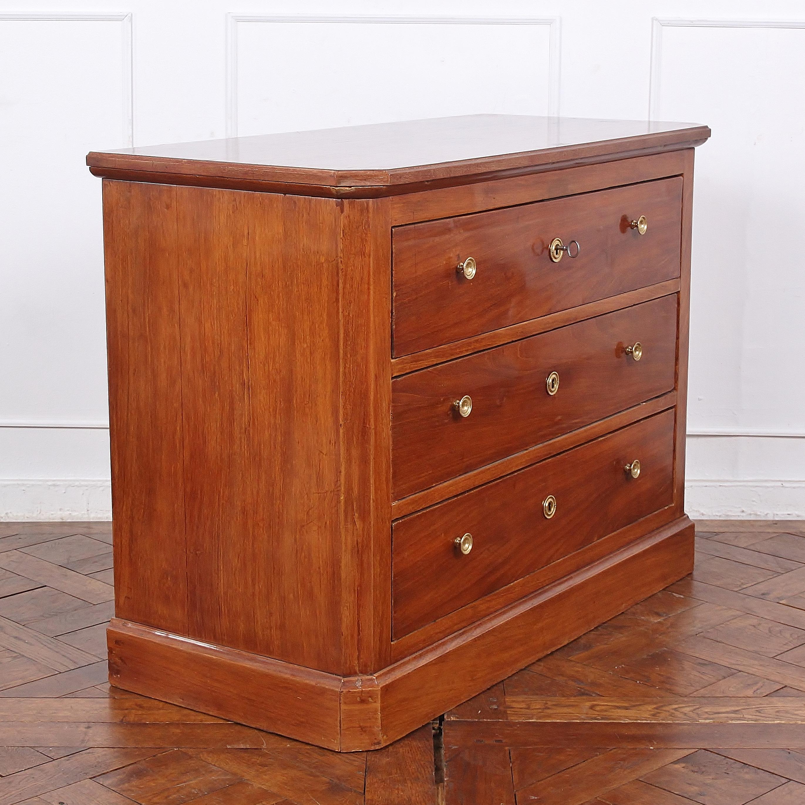 A simple mid-19th century three-drawer Directoire style French commode or chest of drawers in mahogany, the simple geometric case with canted corners and raised on a plinth base. Mellow colour and warm patina.

Provenance from Coco Chanel’s ‘Villa
