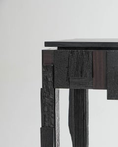 Three-drawer console in black wood