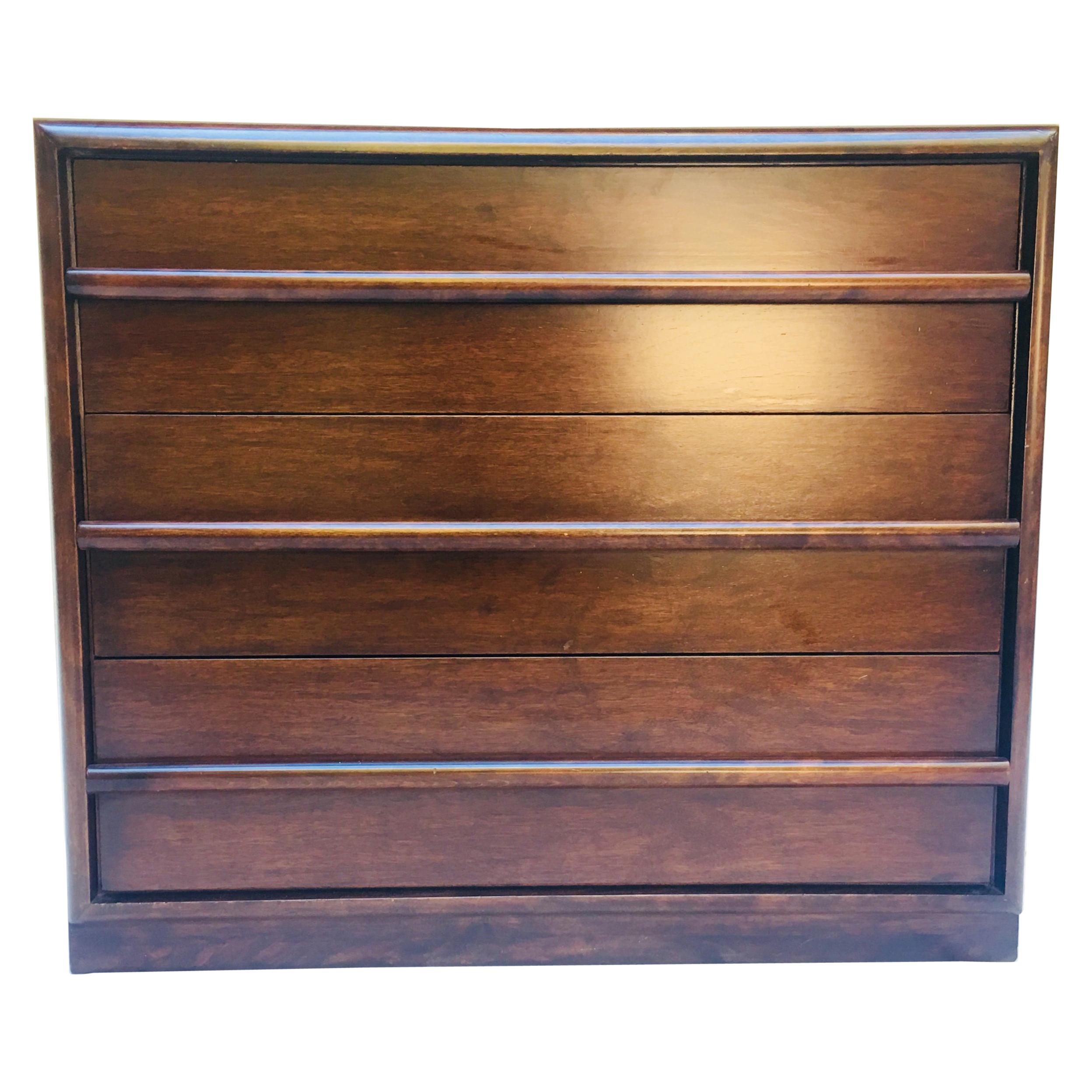 A three-drawer dresser designed by T. H. Robsjohn-Gibbings for Widdicomb, from the 1950s. 
The walnut dresser is in its original Espresso lacquer that has been conserved not refinished and is in excellent vintage condition.
It has its original