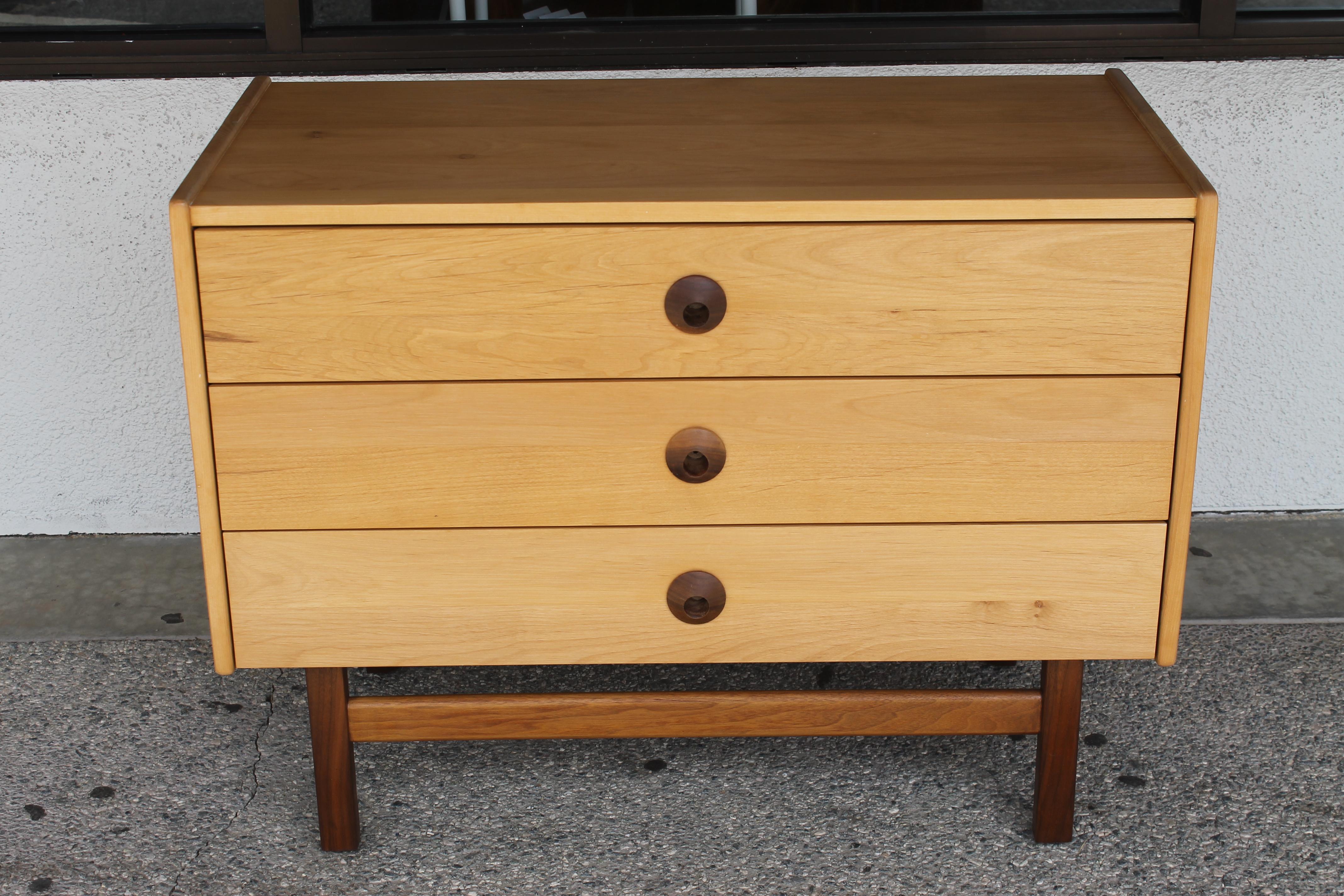Midcentury dresser consisting of 3 drawers. Dresser has been professionally refinished including the inside of each drawer. Dresser measures 36.25