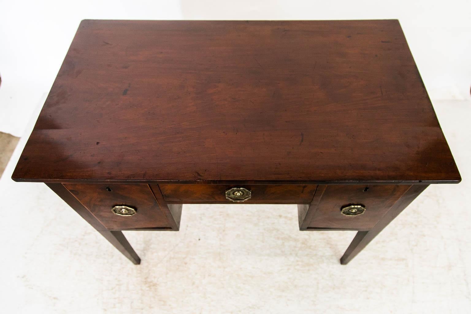 The top of this table has one single board 19 1/2inches deep joined to a two inch board in the rear. The drawer fronts are flamegrained mahogany and are banded with boxwood edging. There is some spotting on the left hand drawer.
