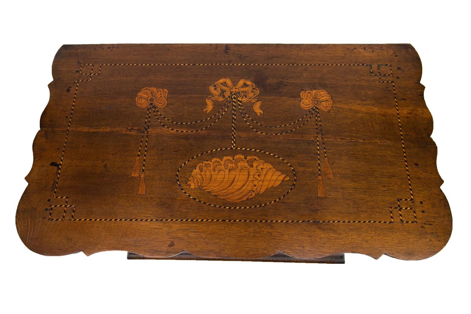 Three-drawer English oak inlaid chest, inlaid with elaborate conch shells and ribbon drapery on the top, drawer fronts and sides. The top has a scalloped shape on three sides.