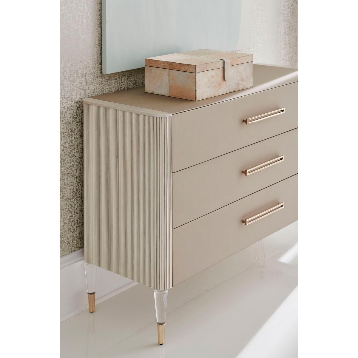 Unforgettable from every perspective, this stylish chest will woo you at first sight. With an inspired mix of materials. Its unique fluted sides and textured vinyl drawer fronts (and top) are brought to life in shades of Whisper of Gold and Matte