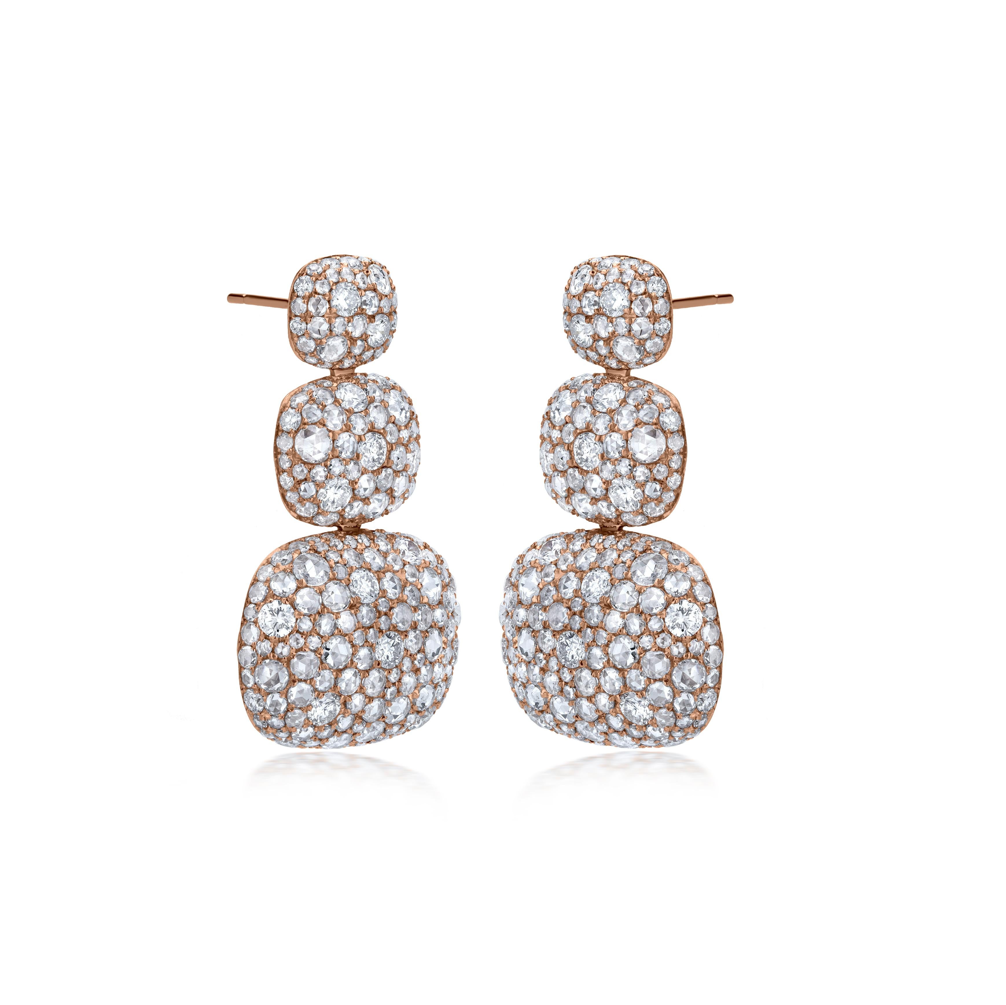 This gleaming Nigaam Dangle earring features three- graduating diamond studded drops mounted on 18k rose gold. The 7.65-carat round-rose cut diamonds are prong set and have G-H color and SI1 & I1 clarity. The Dangle earring comes with a push-button