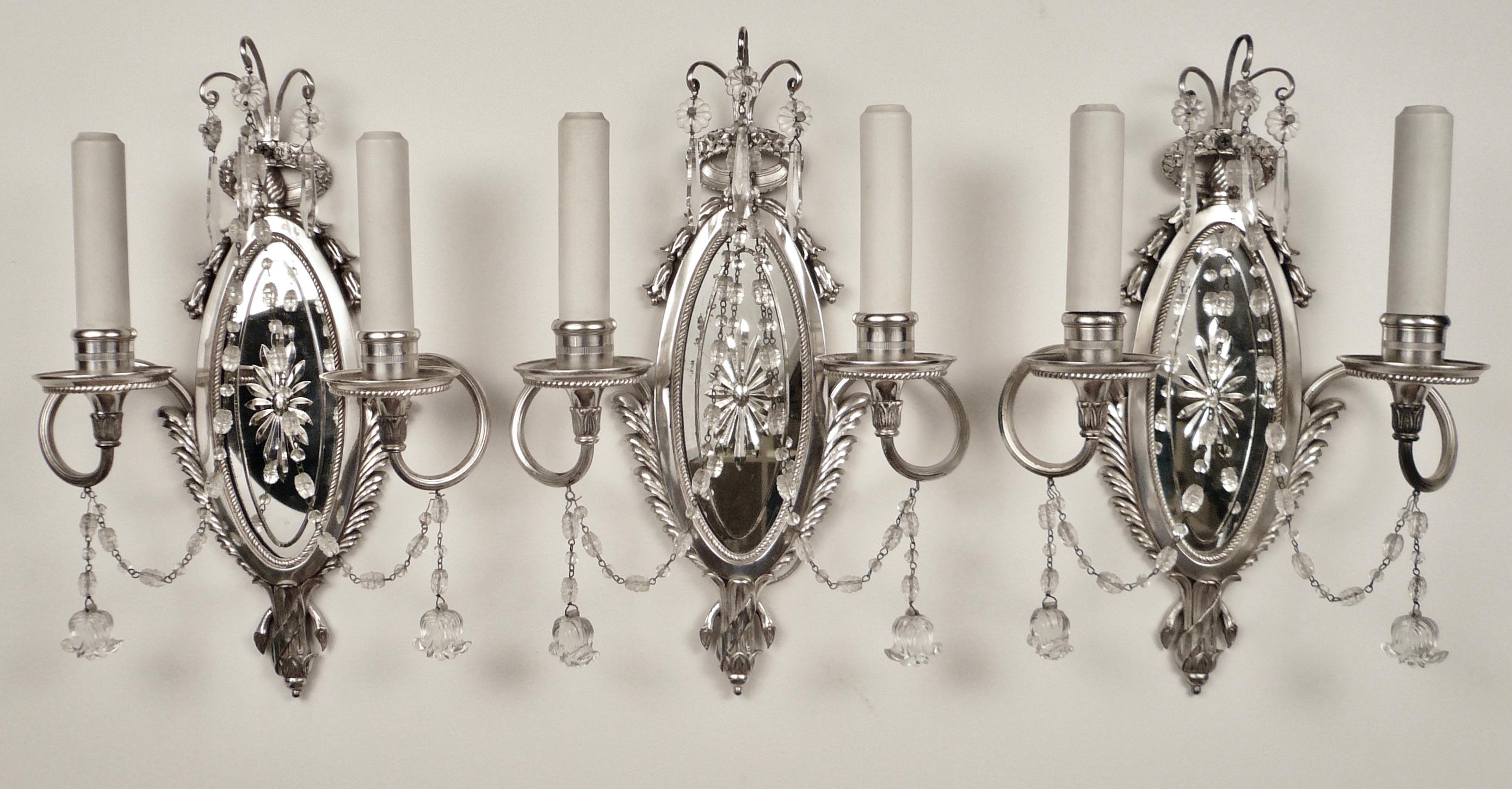 This set of three Caldwell sconces feature classic Georgian motifs made popular by Robert Adam.
They include palm and acanthus leaves, bellflowers and oval wheel cut mirrored backs.