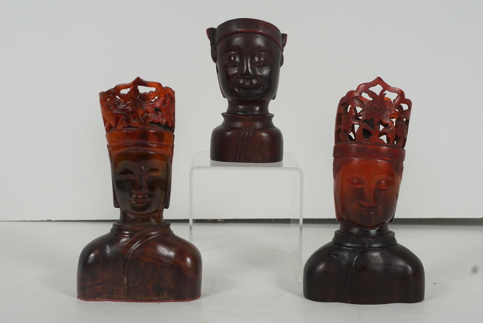 Three early 20th century red horn carvings of Buddha and Bodhisattvas. These three carvings all from approx. circa 1915 represent the bodhisattvas and or the Buddha. Carved from Ox horn with a deep red color the busts are then mounted on rosewood